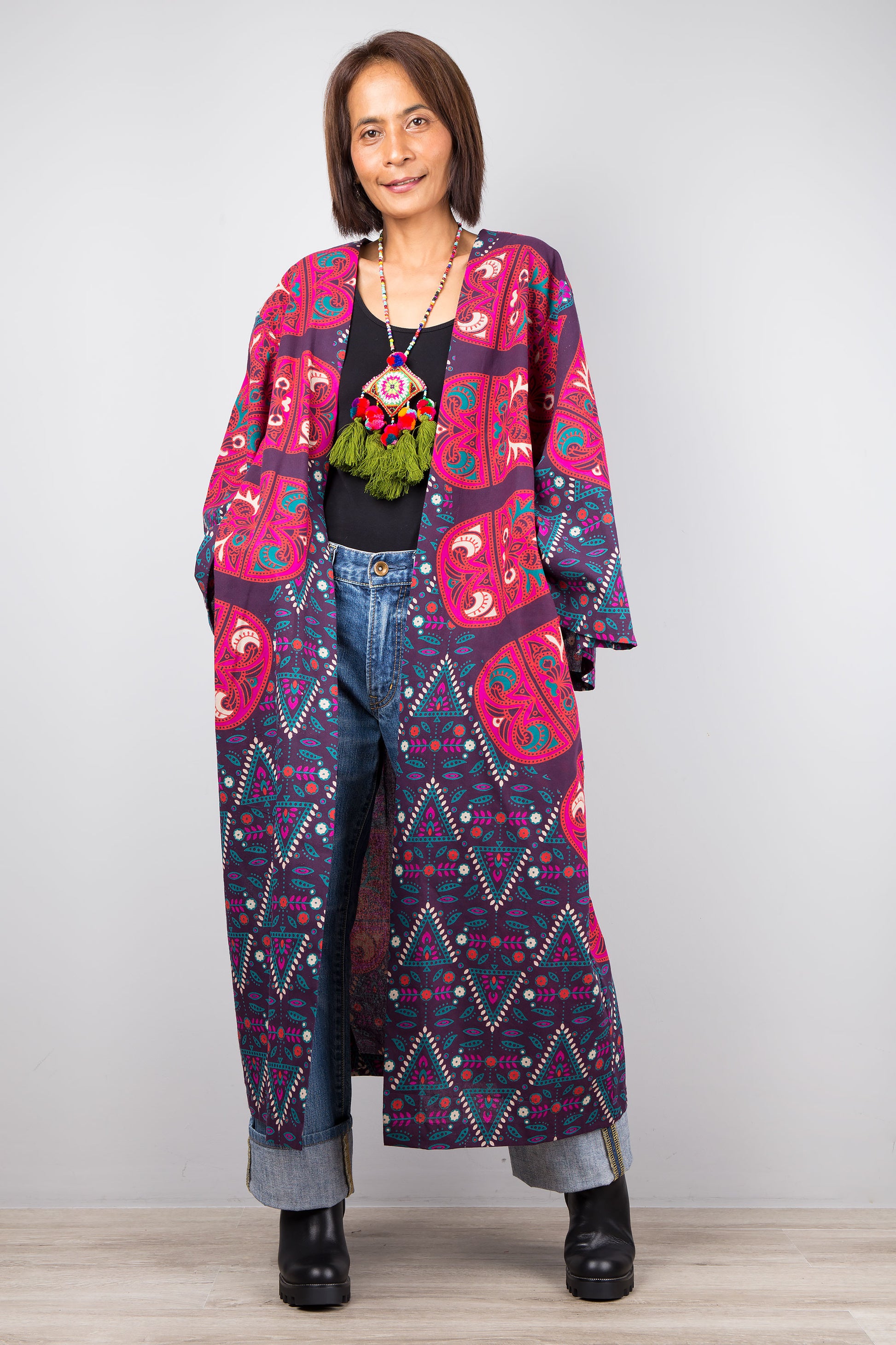 Long open front cardigan with pockets featuring a big mandala print on the back.  Purple and dark pink color tones.