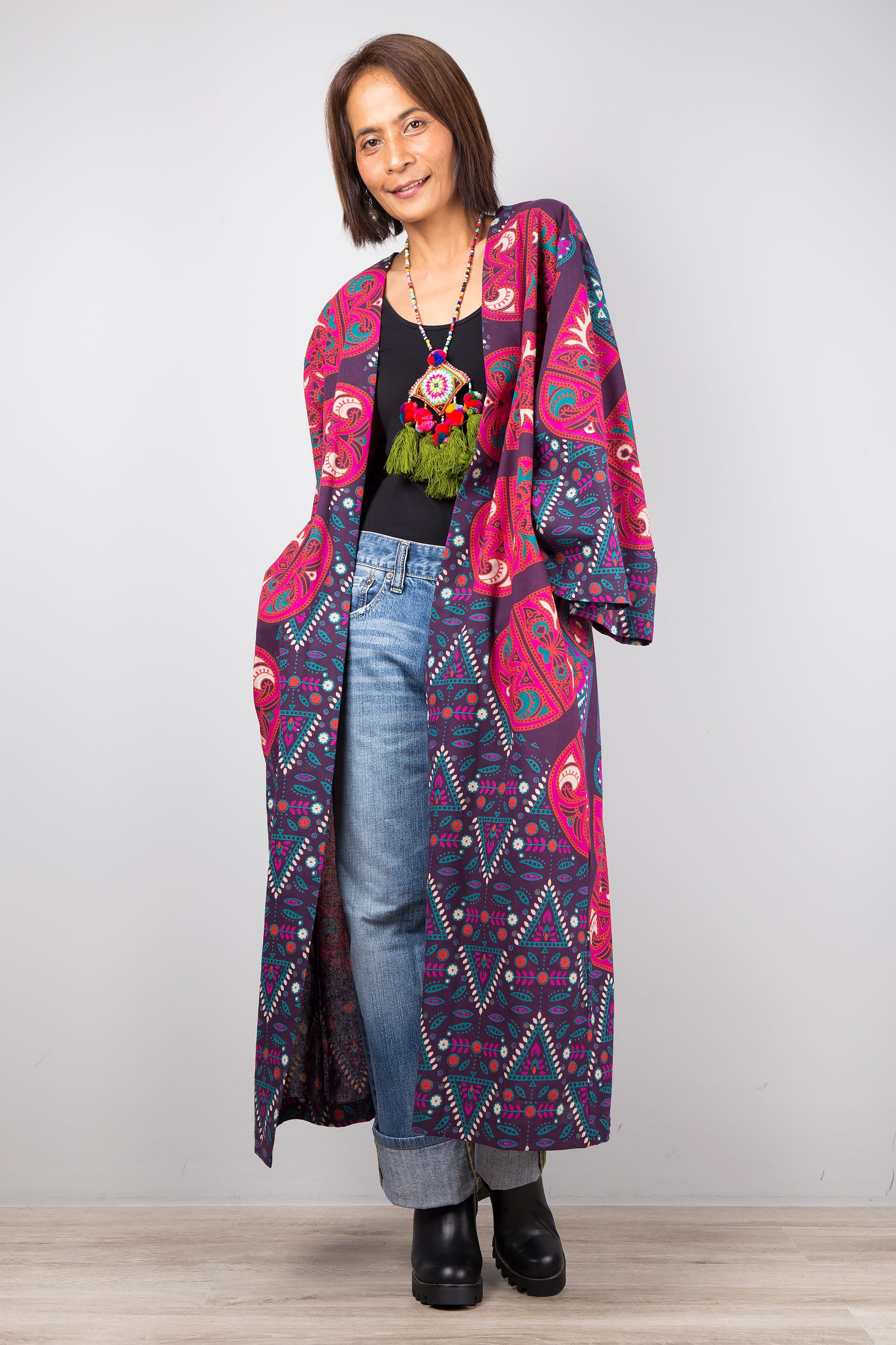 Long open front cardigan with pockets featuring a big mandala print on the back.  Purple and dark pink color tones.