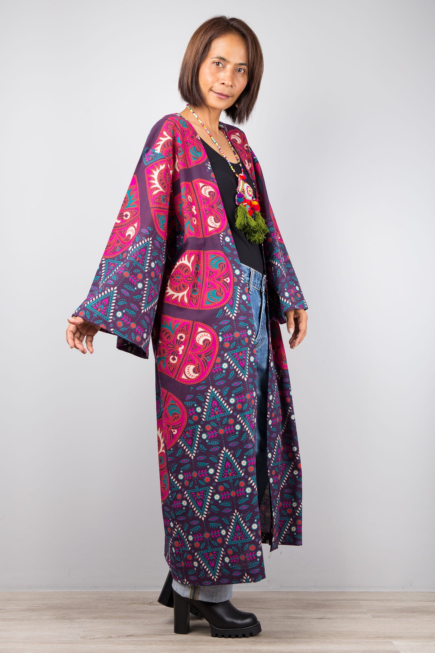 Long open front cardigan with pockets featuring a big mandala print on the back.  Purple and dark pink color tones.