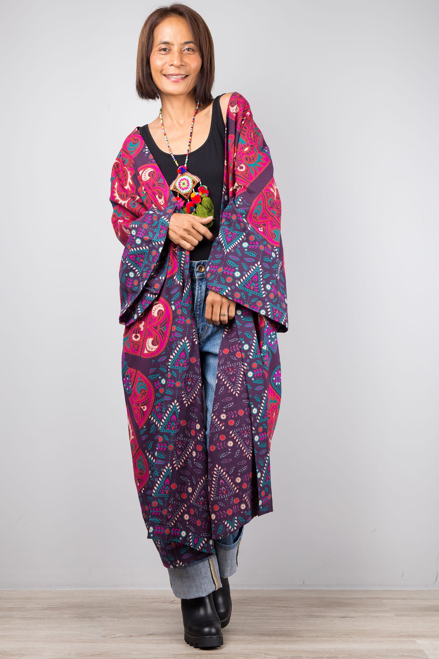 Long open front cardigan with pockets featuring a big mandala print on the back.  Purple and dark pink color tones.