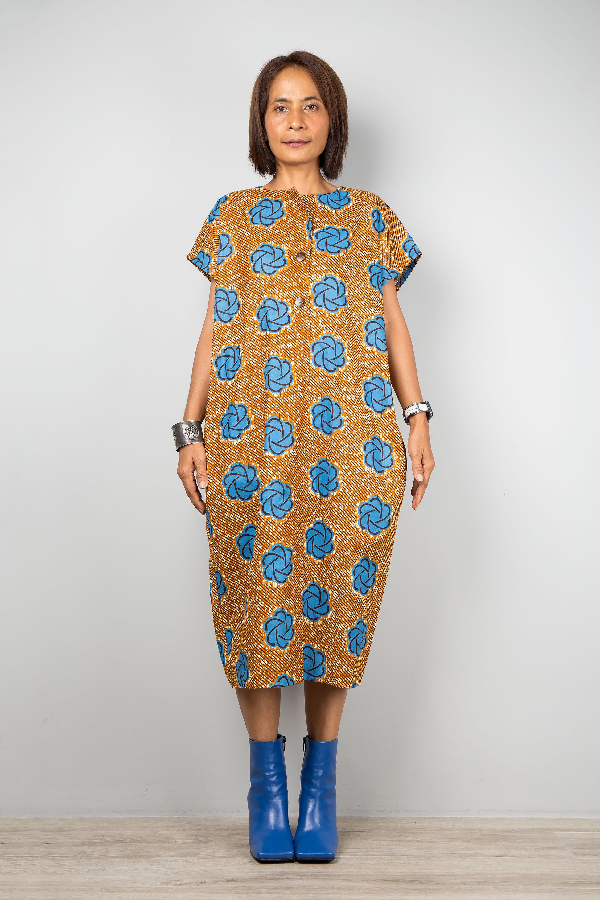 Mid length cotton ankara dress with blue print. Front view of a dress with cap sleeves and african print