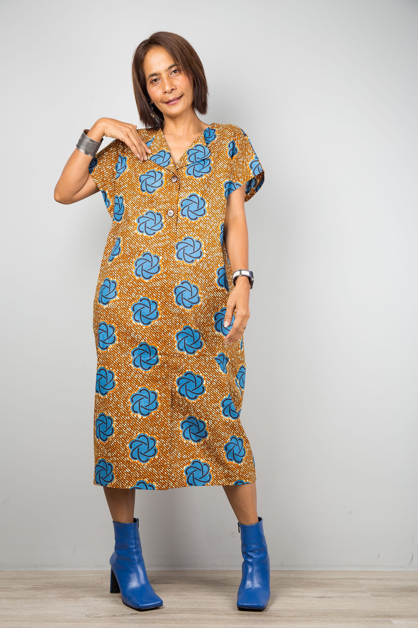 Mid length cotton ankara dress with blue print. Front view of a dress with cap sleeves and african print
