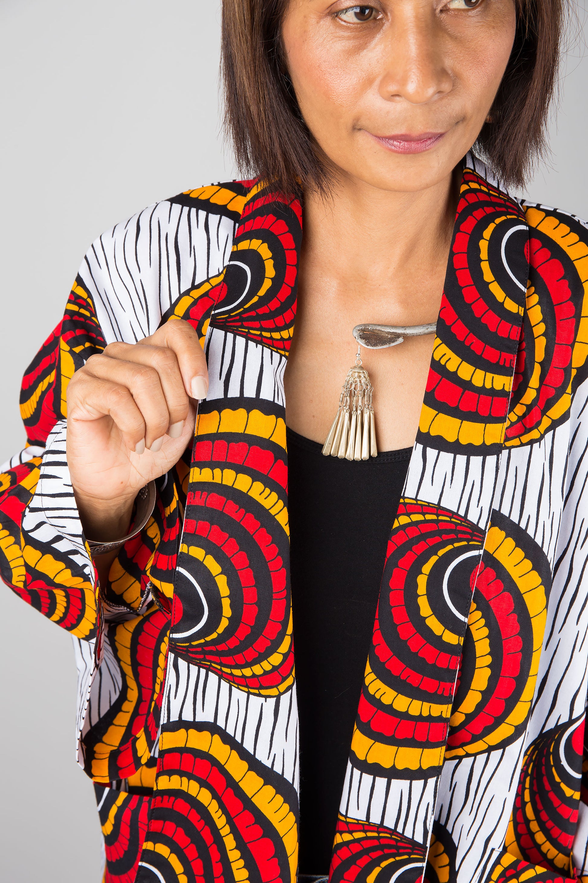 African kimono jacket top.  Short jacket top in ankara fabric. Close up view