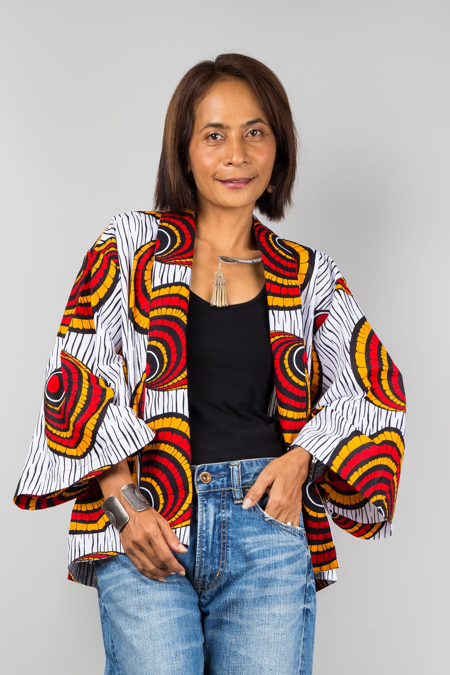 African kimono cardigan top.  Short jacket top in ankara fabric. Close up view.