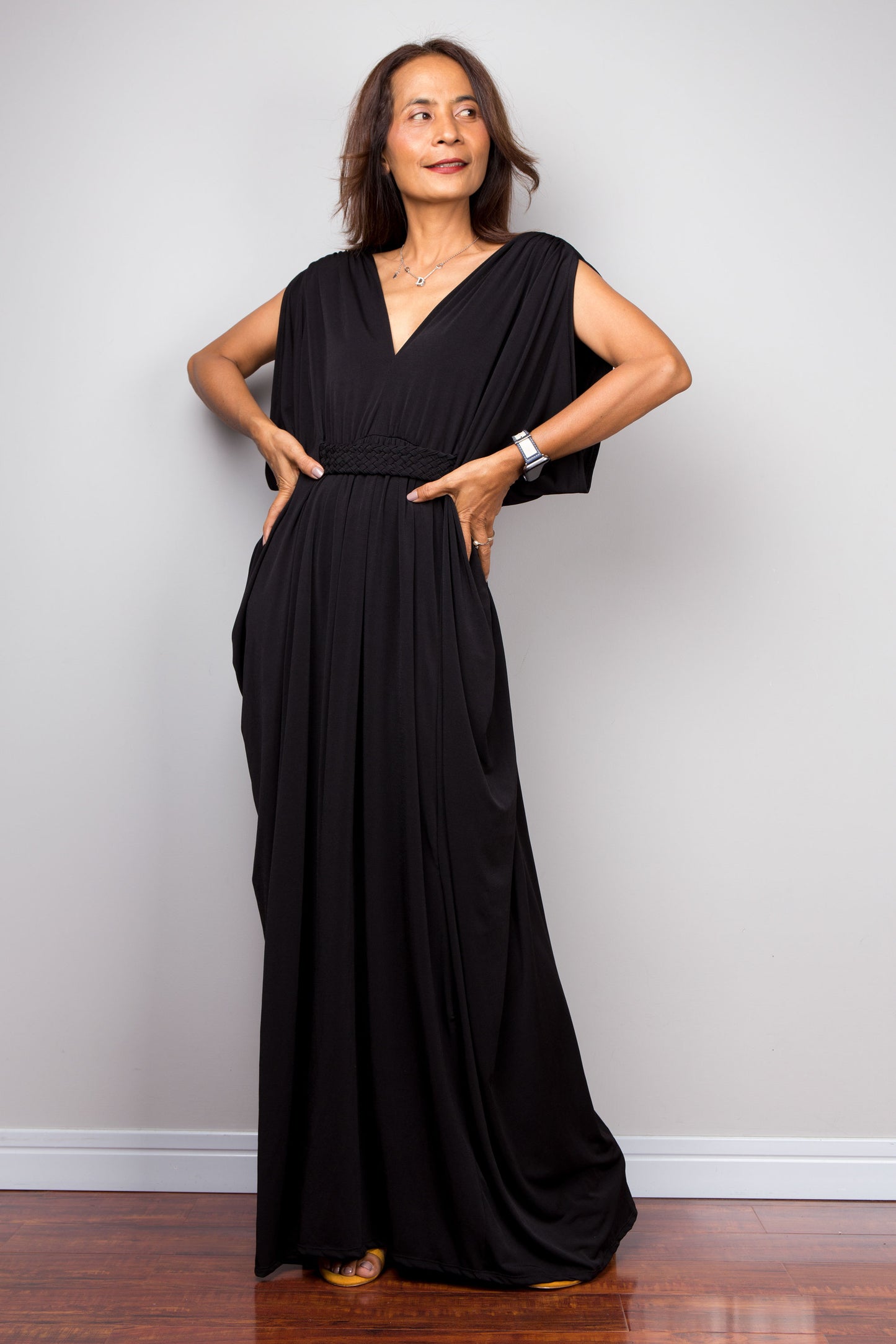 Long black kaftan dress with v neck and braided detail on the waist. Black kaftan with batwing sleeves