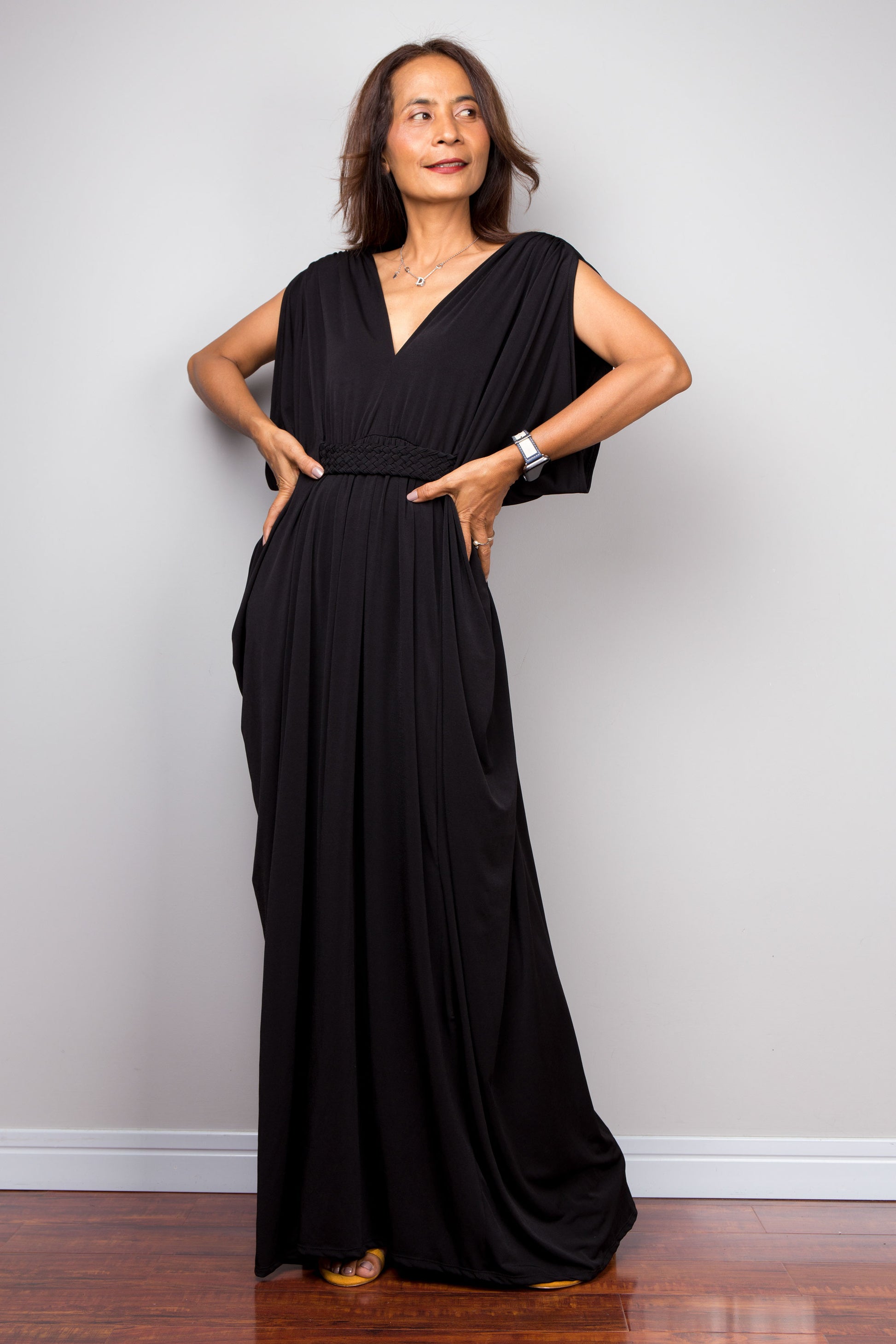 Long black kaftan dress with v neck and braided detail on the waist. Black kaftan with batwing sleeves