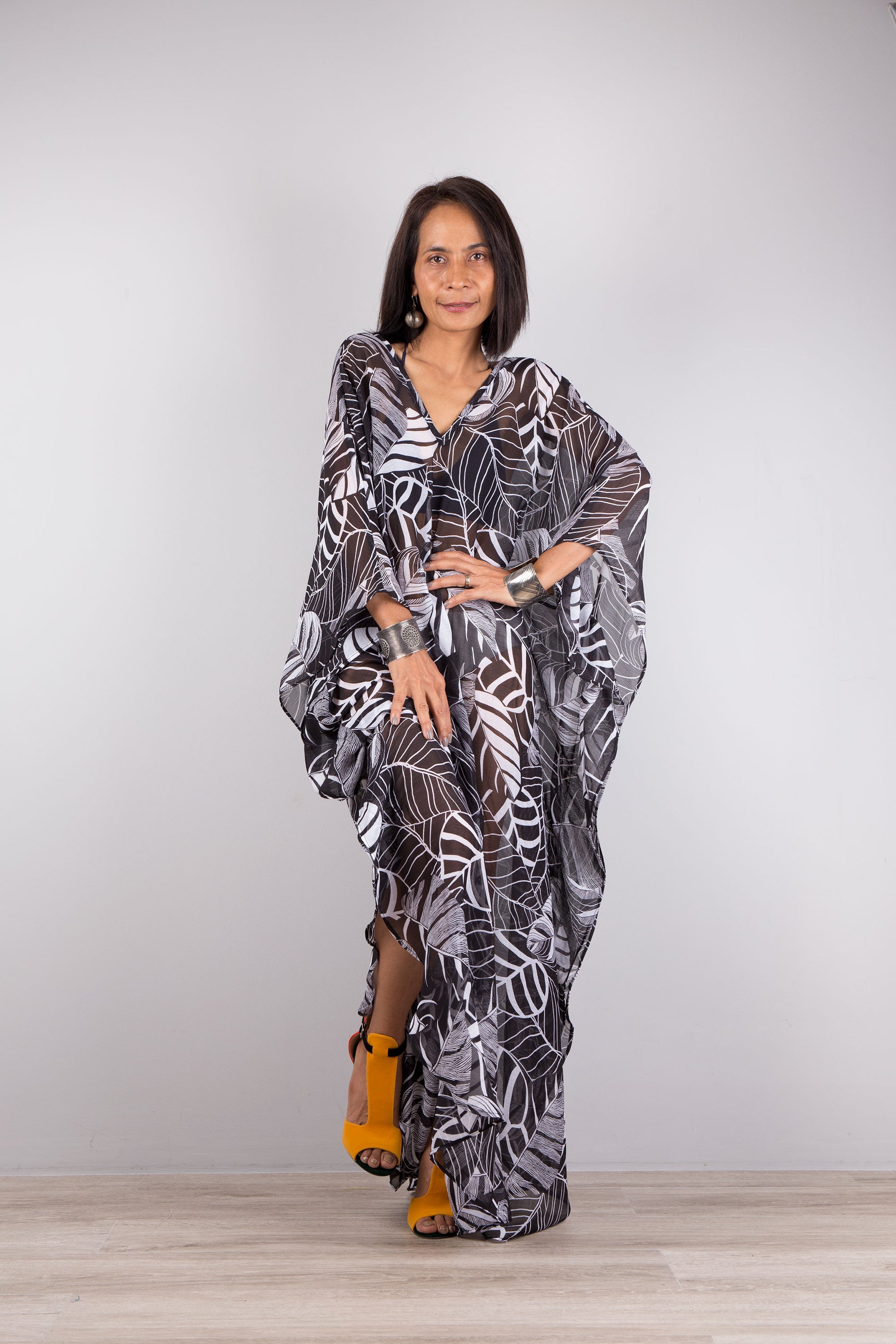 Chiffon kaftan dress in black and white. Loose fit caftan with subtle v neck and batwing sleeves. Sheer beach dress