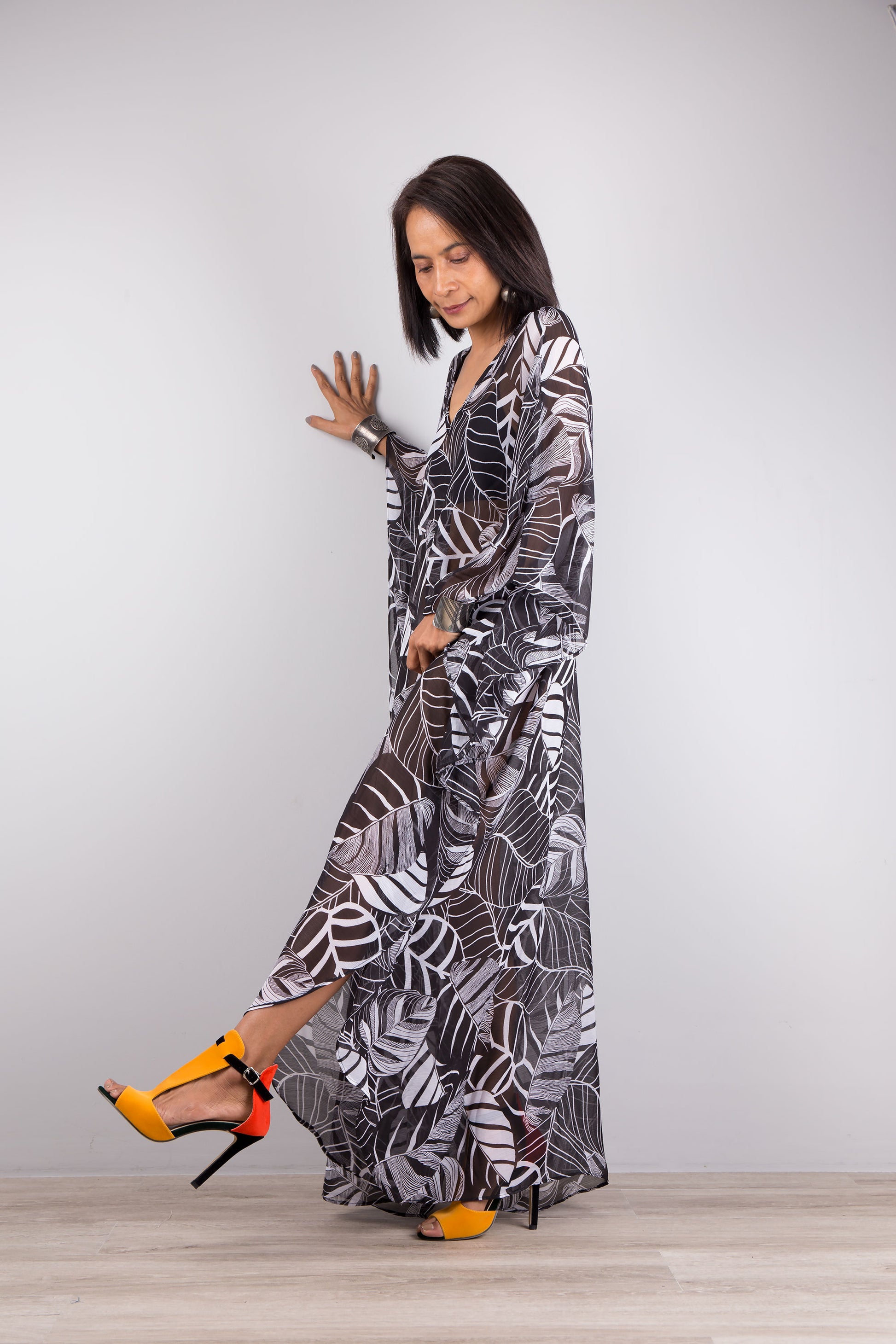 Chiffon kaftan dress in black and white. Loose fit sheer caftan with subtle v neck and batwing sleeves