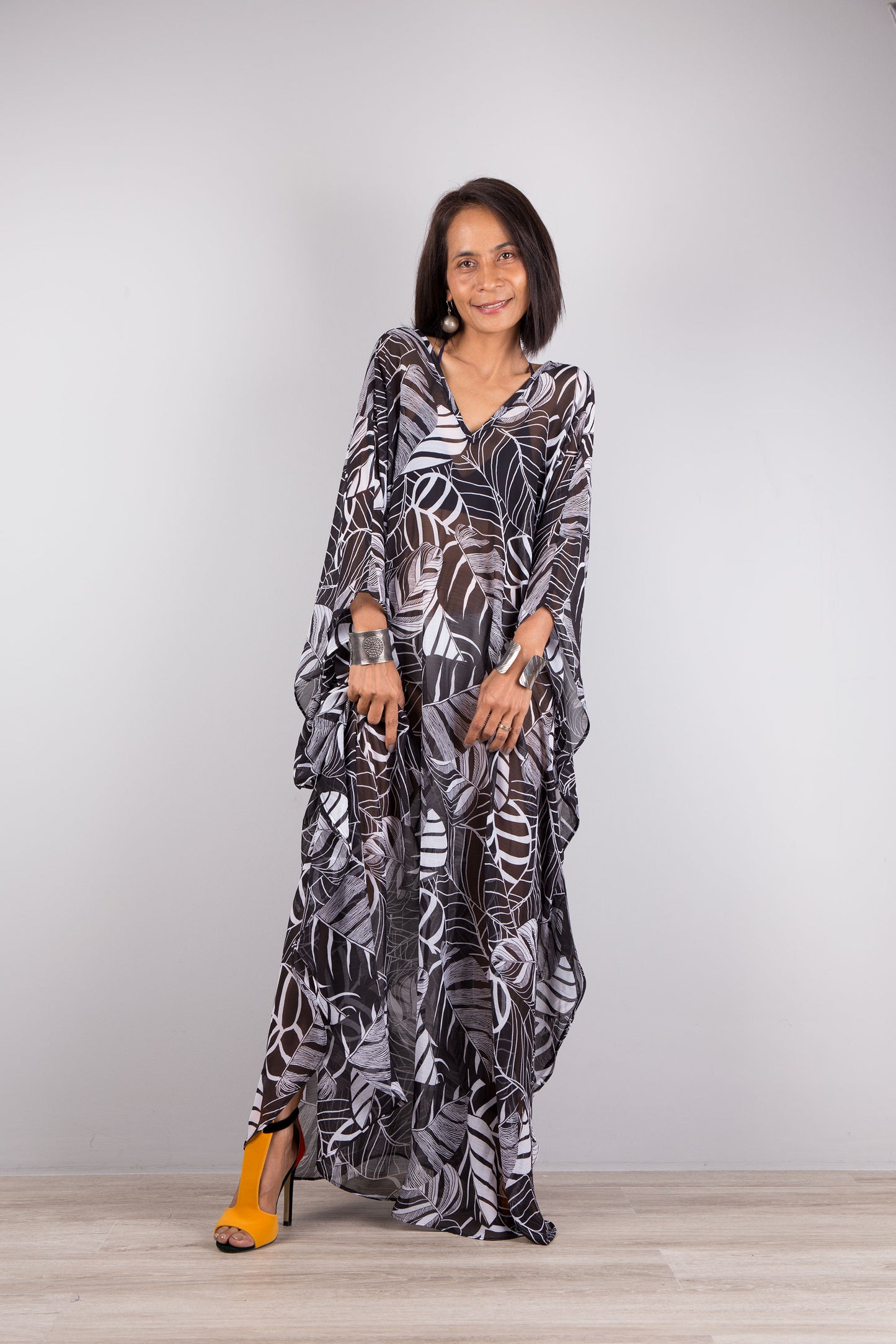 Chiffon kaftan dress in black and white. Loose fit caftan with subtle v neck and batwing sleeves. Front view