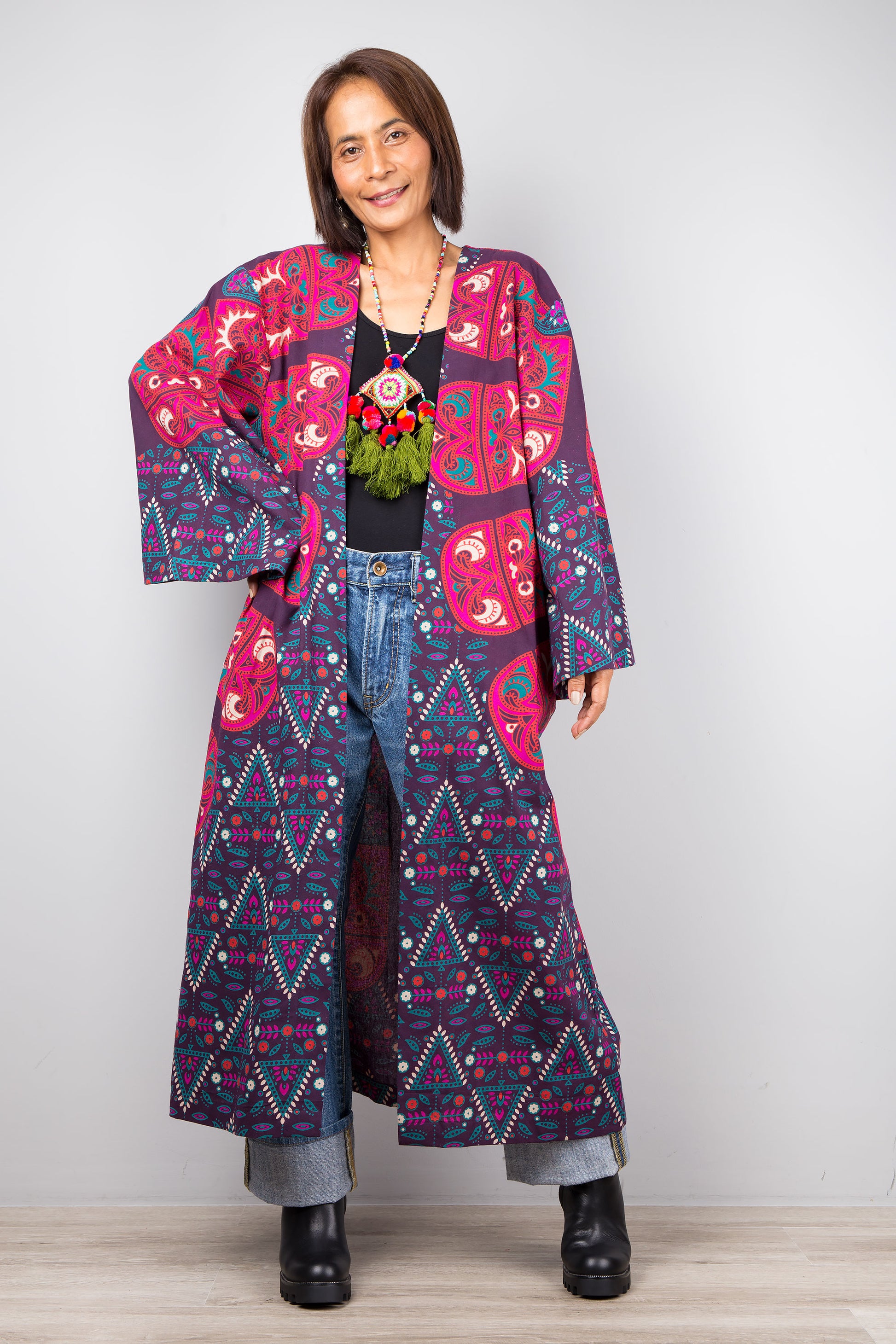 Long open front cardigan with pockets featuring a big mandala print on the back.  Purple and dark pink color tones.