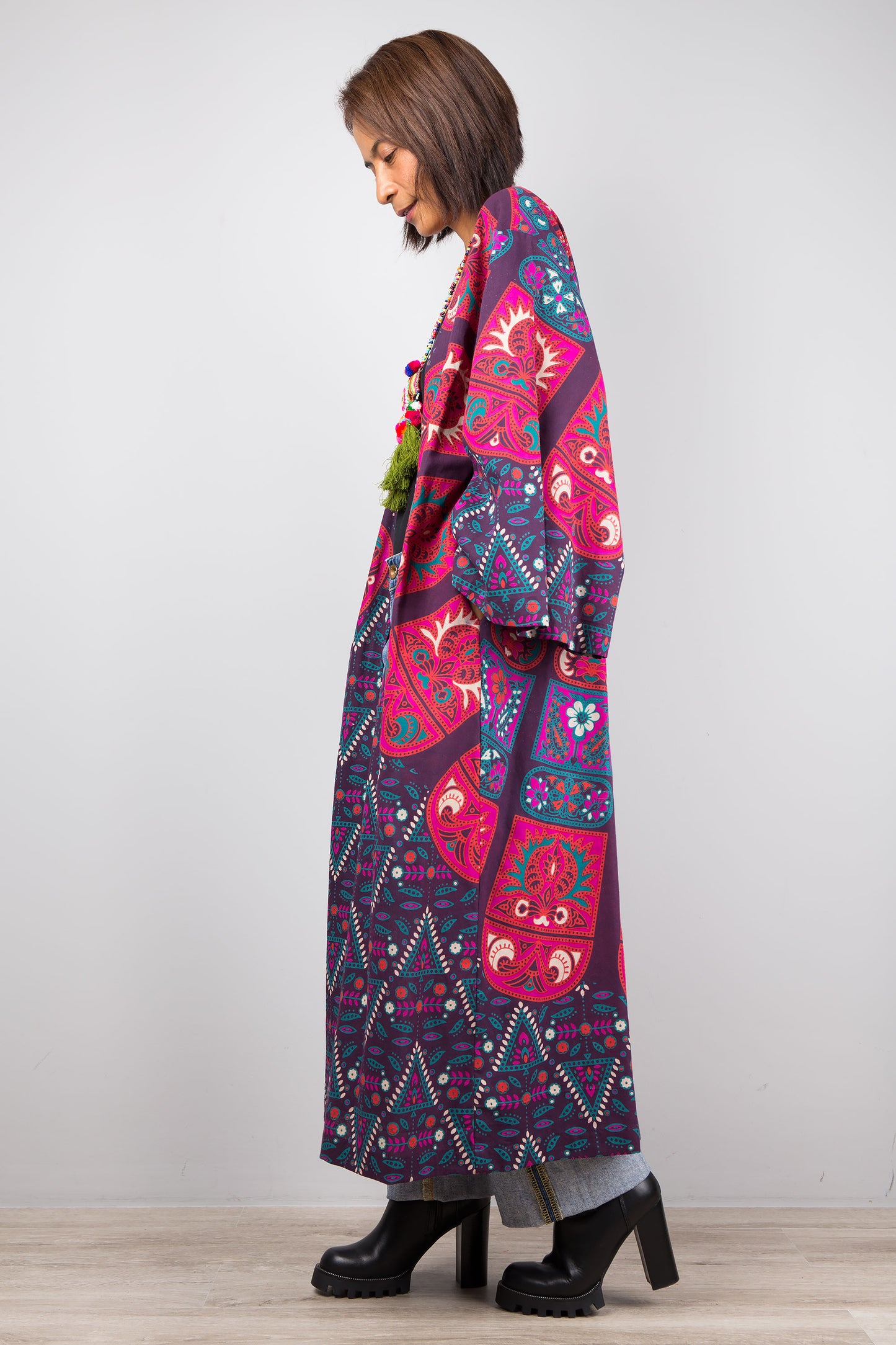 Long open front cardigan with pockets featuring a big mandala print on the back.  Purple and dark pink color tones.