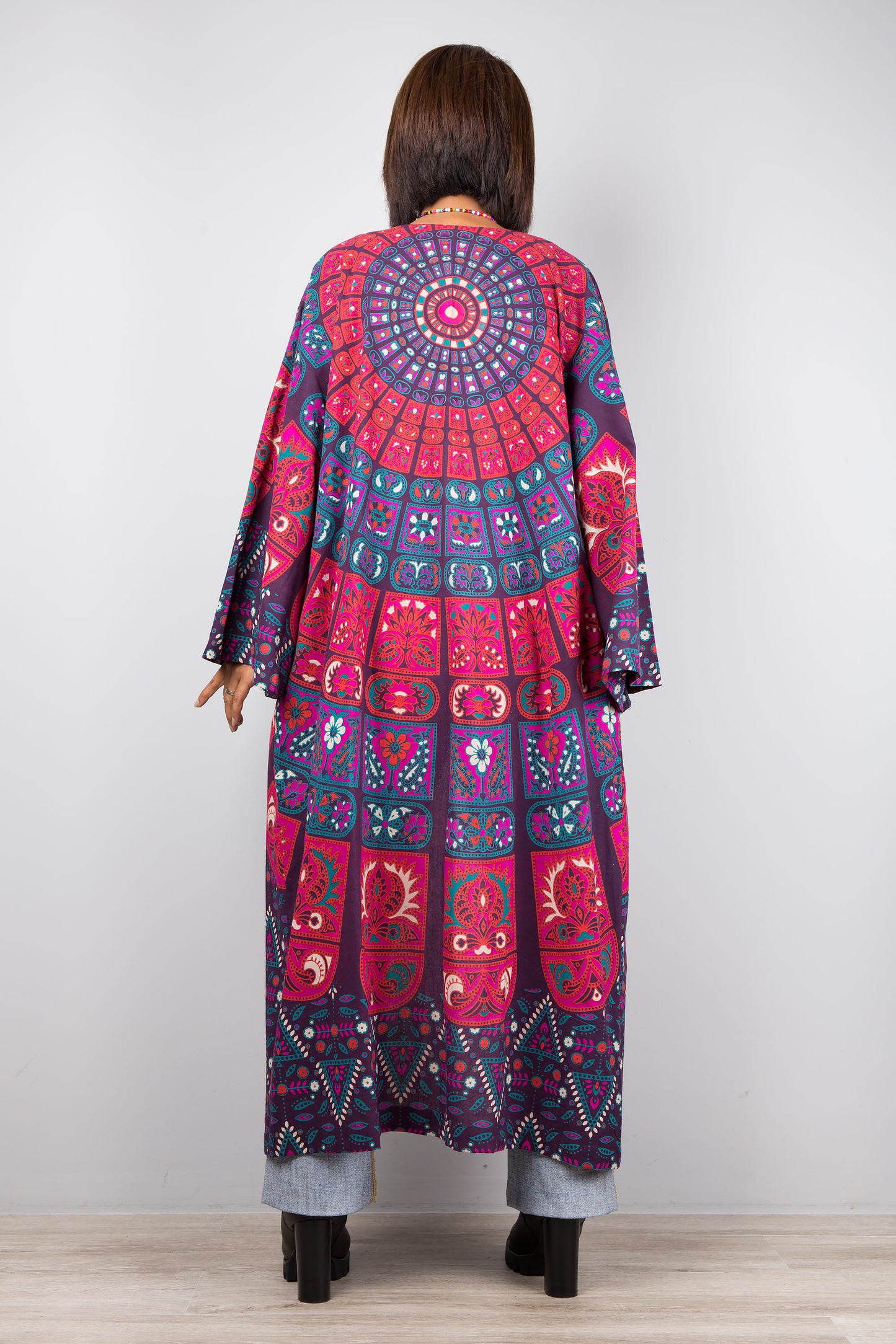 Long open front cardigan with pockets featuring a big mandala print on the back.  Purple and dark pink color tones.