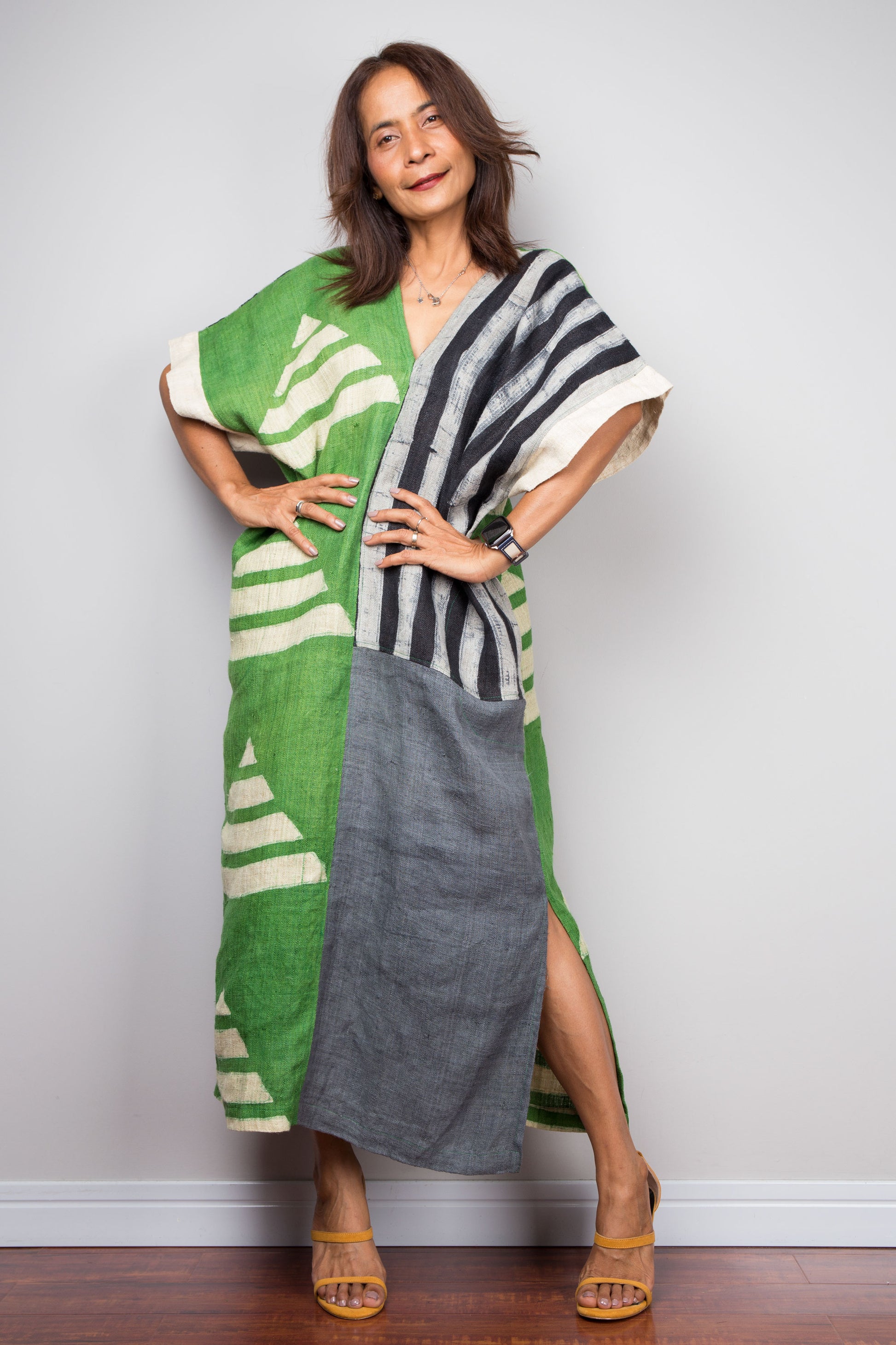 Two tone kaftan dress in grey and green. Caftan style with subtle v neck and pockets on both sides. Pyramid batik shapes on the green fabric,  Stripes on the grey part of the dress