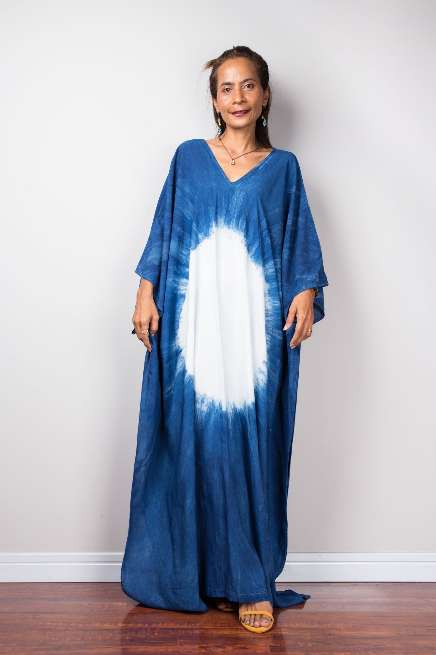 Indigo blue kaftan dress with big white circle on the front.  Loose fitting caftan with v neck