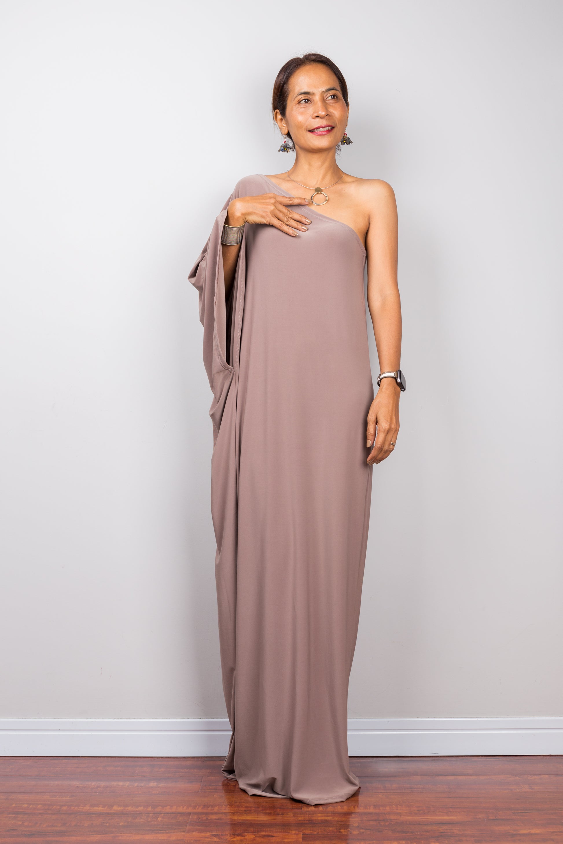 Long taupe dress with asymmetrical sleeve design.  Taupe kaftan dress