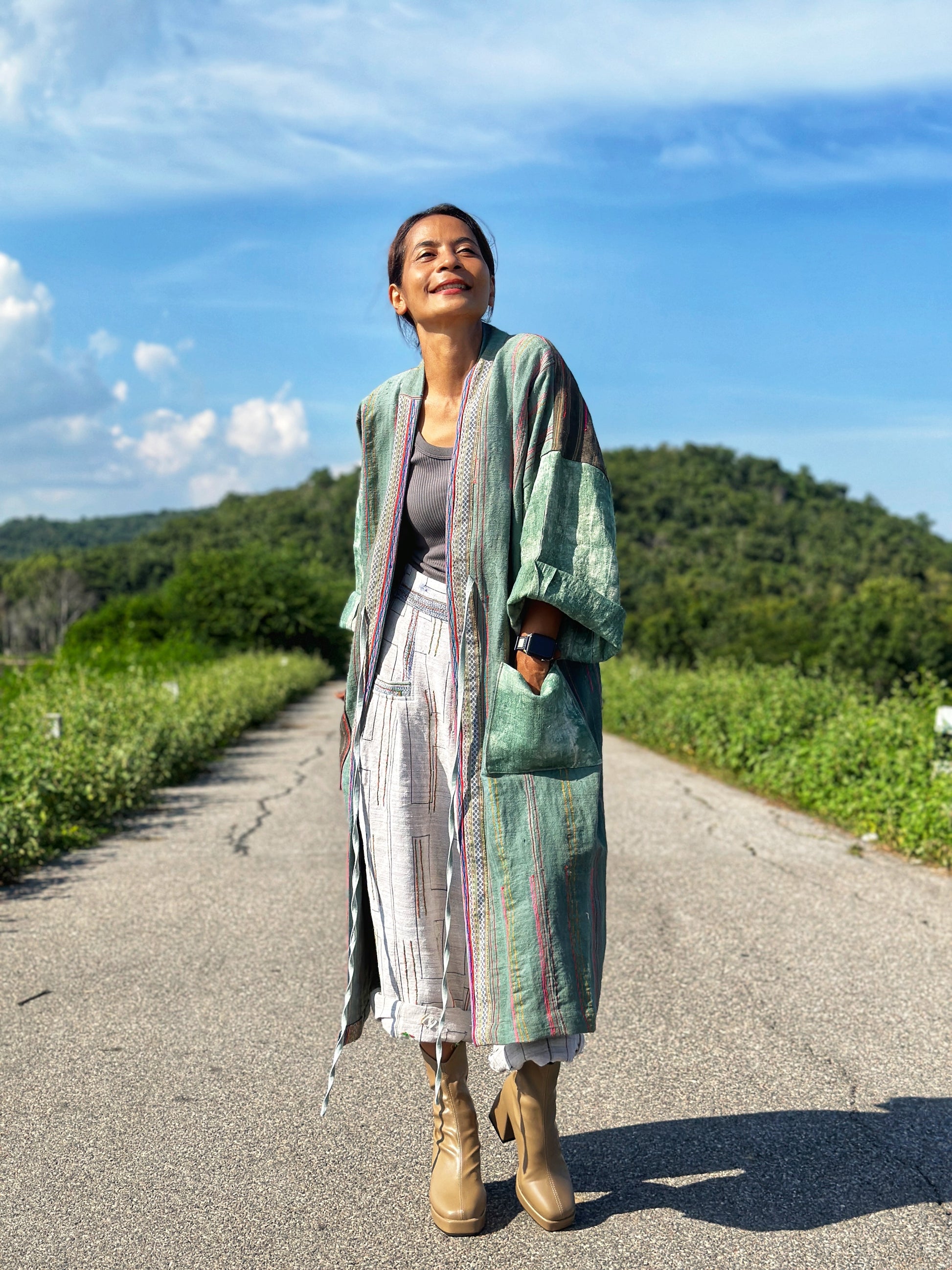 Open front cardigan in green handwoven hemp with embroidery details on the pocket and back