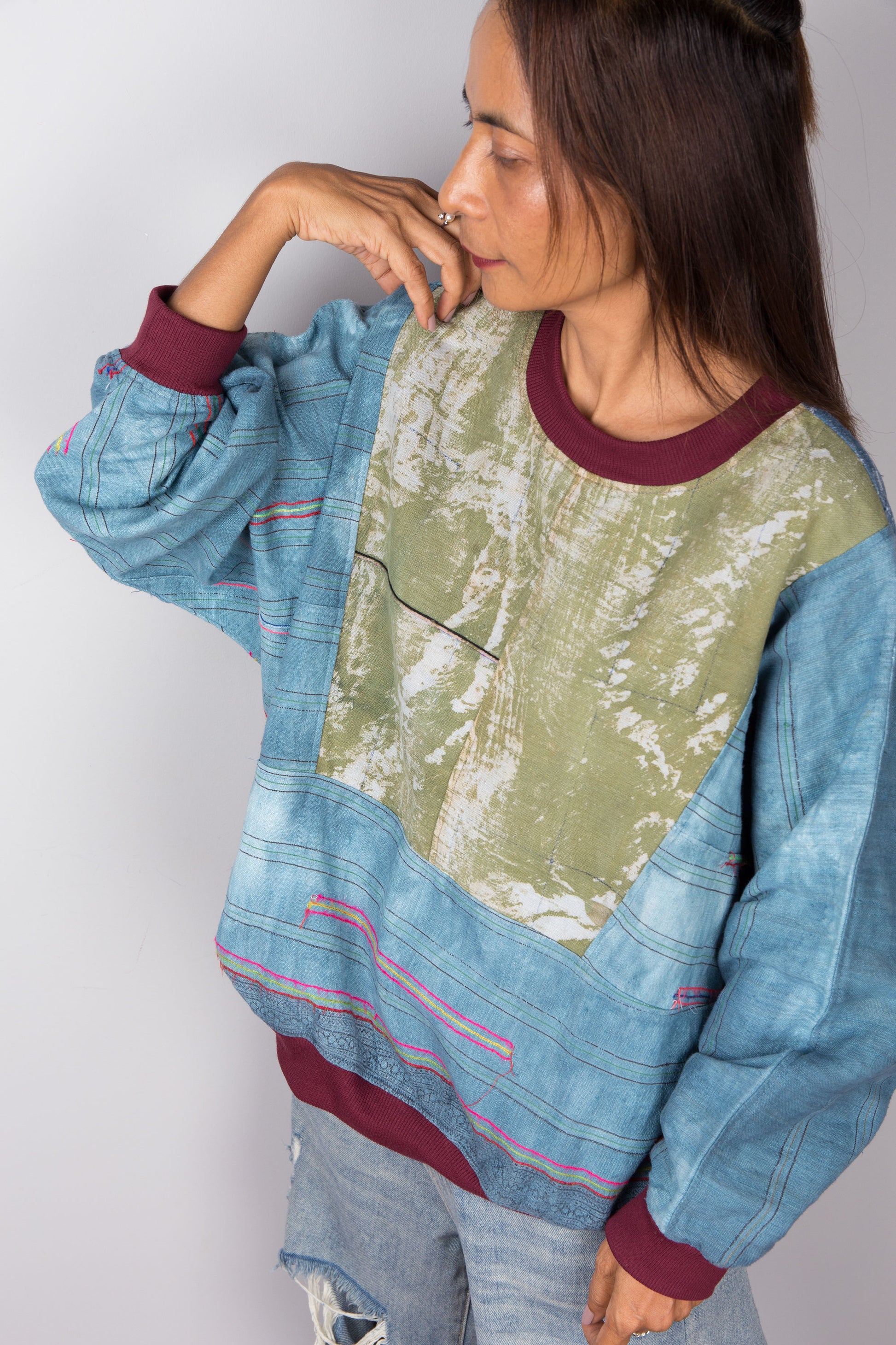 Top down view of a blue and green tie dye coloured hemp sweater by Nuichan