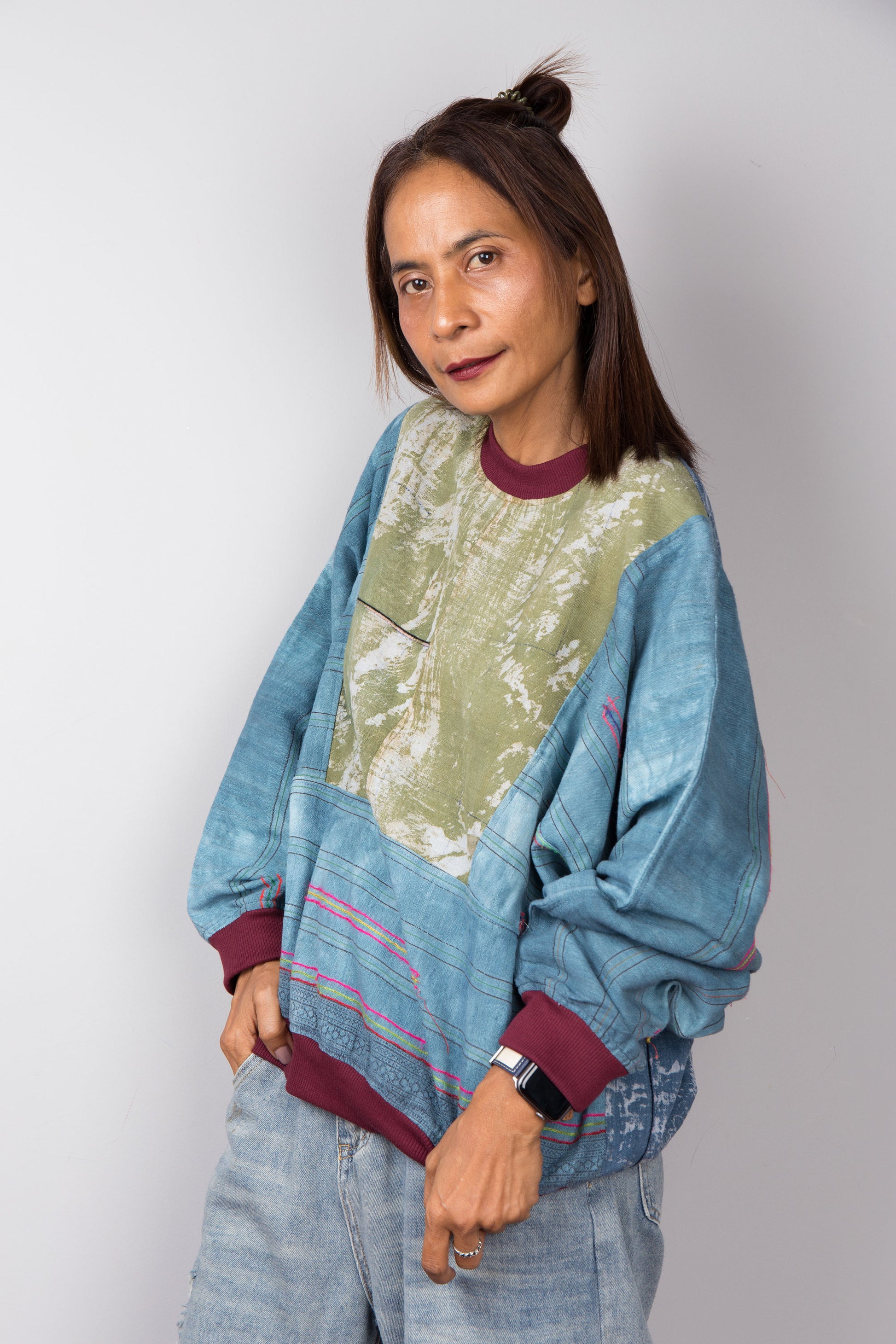 Side view of a blue and green sweater by Nuichan.  Handwoven hemp fabric with tie dye colouring.