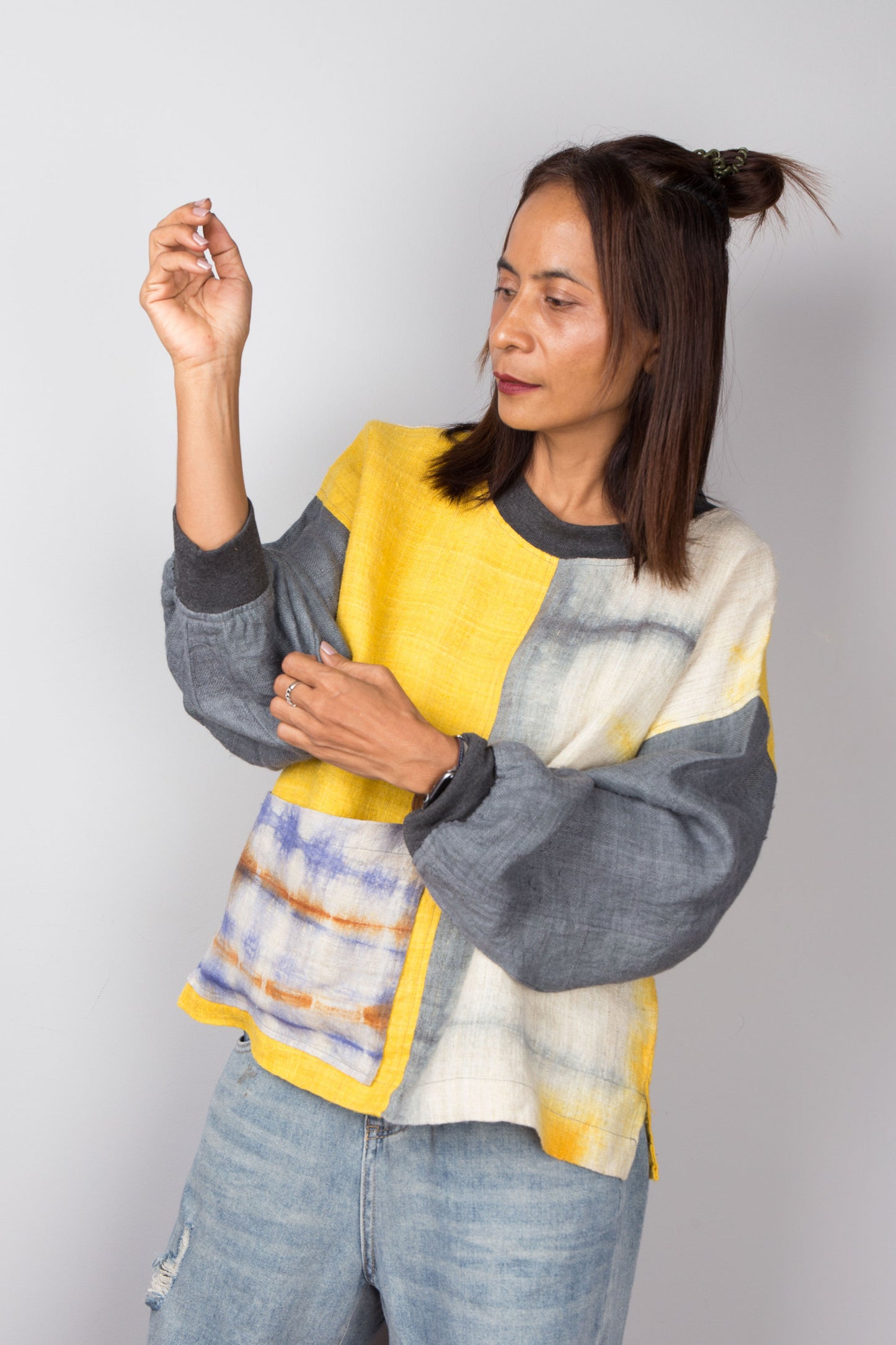 Hemp sweater in yellow and grey with shibori tie dye detail on the front pocket