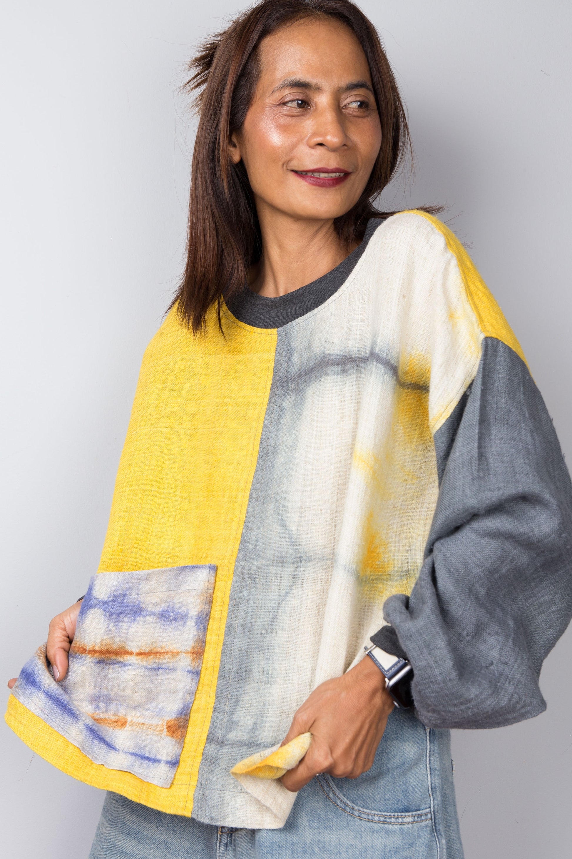 Hemp sweater in yellow and grey with shibori tie dye detail on the front pocket. Nuichan design.