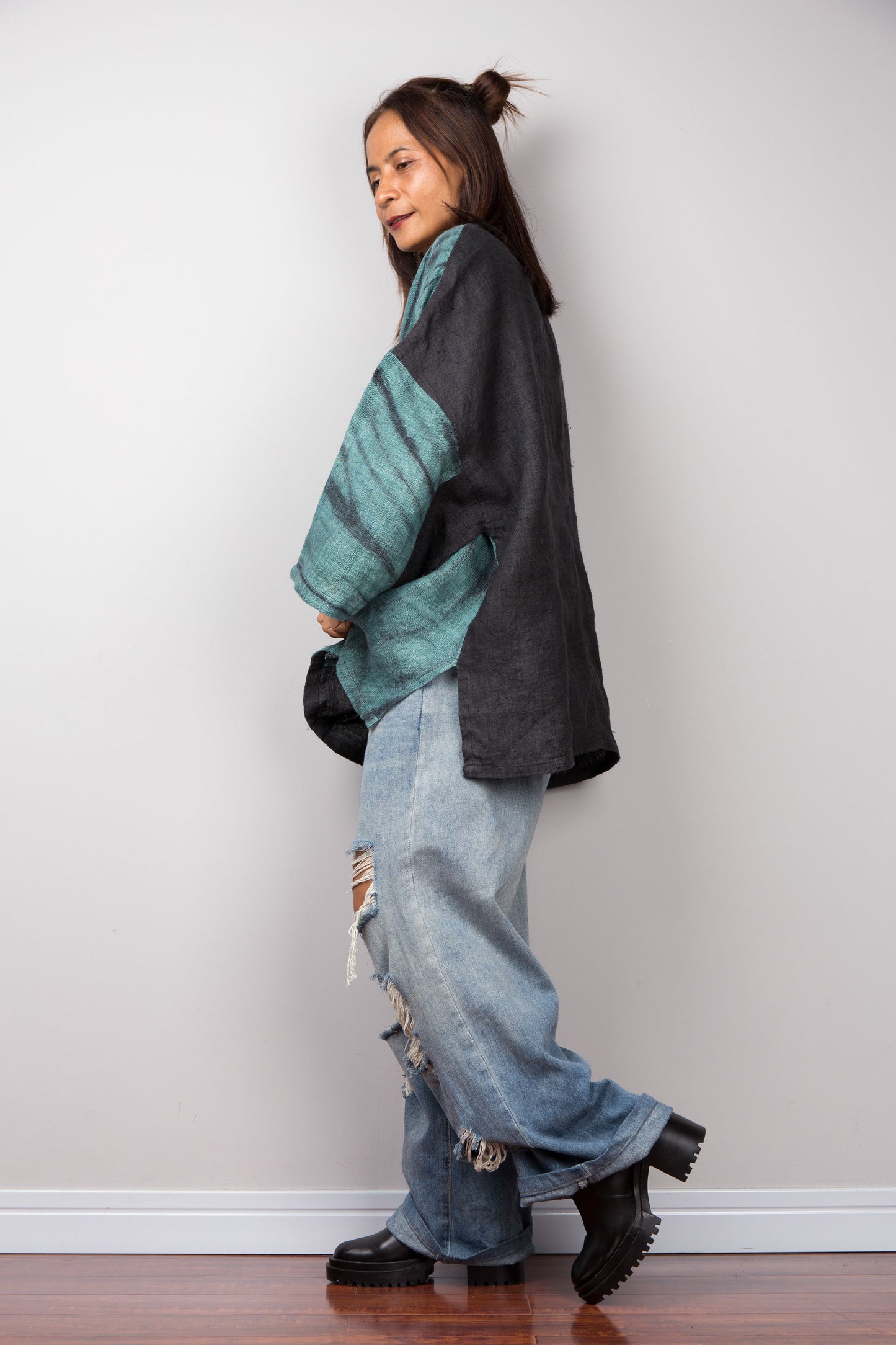 Two tone oversized shirt with big front pocket. Black and green tones with shibori tie dye detail. Side view