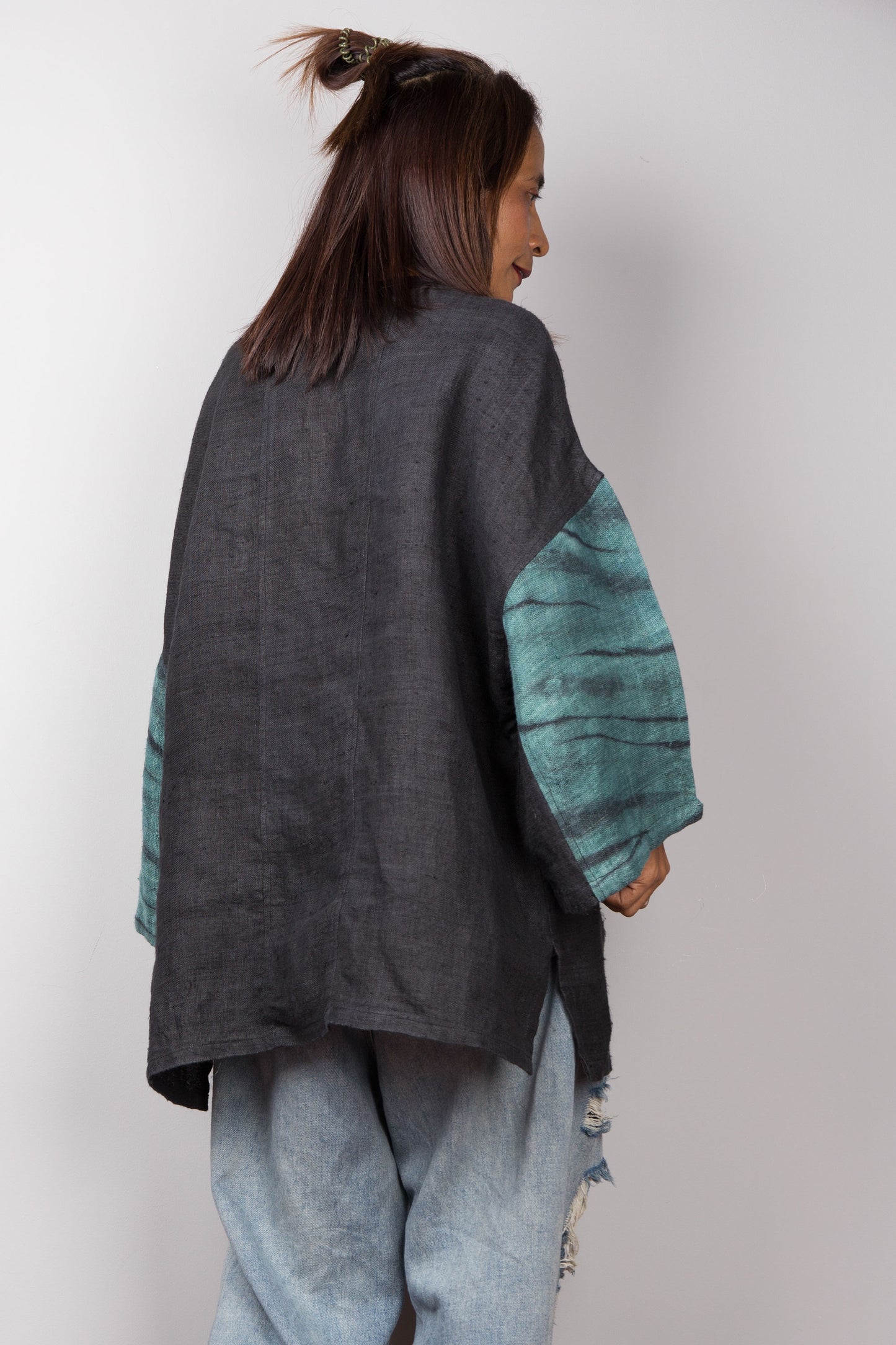 Two tone oversized shirt with big front pocket. Black and green tones with shibori tie dye detail. Back view