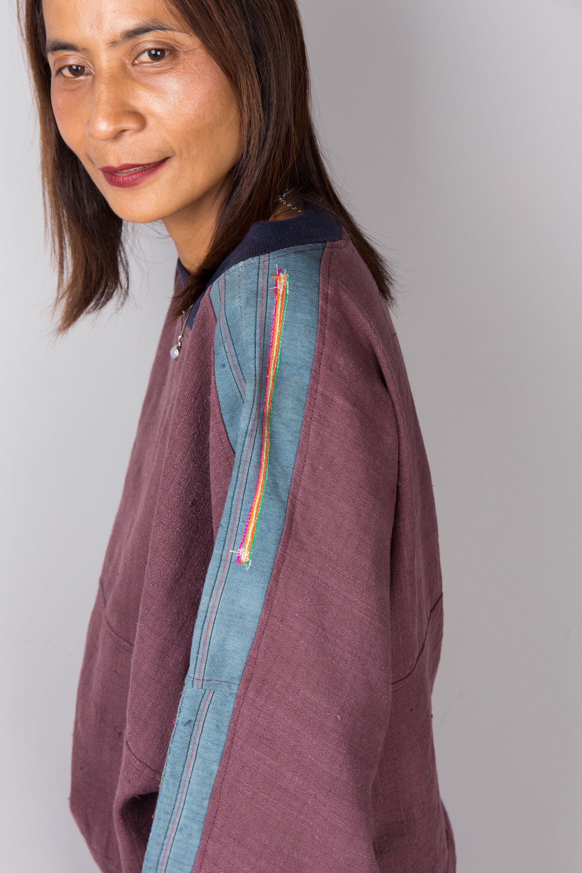 Maroon purple sweater with crew neck and light blue strip running over the shoulder and sleeves.  Handwoven hemp pullover by Nuichan