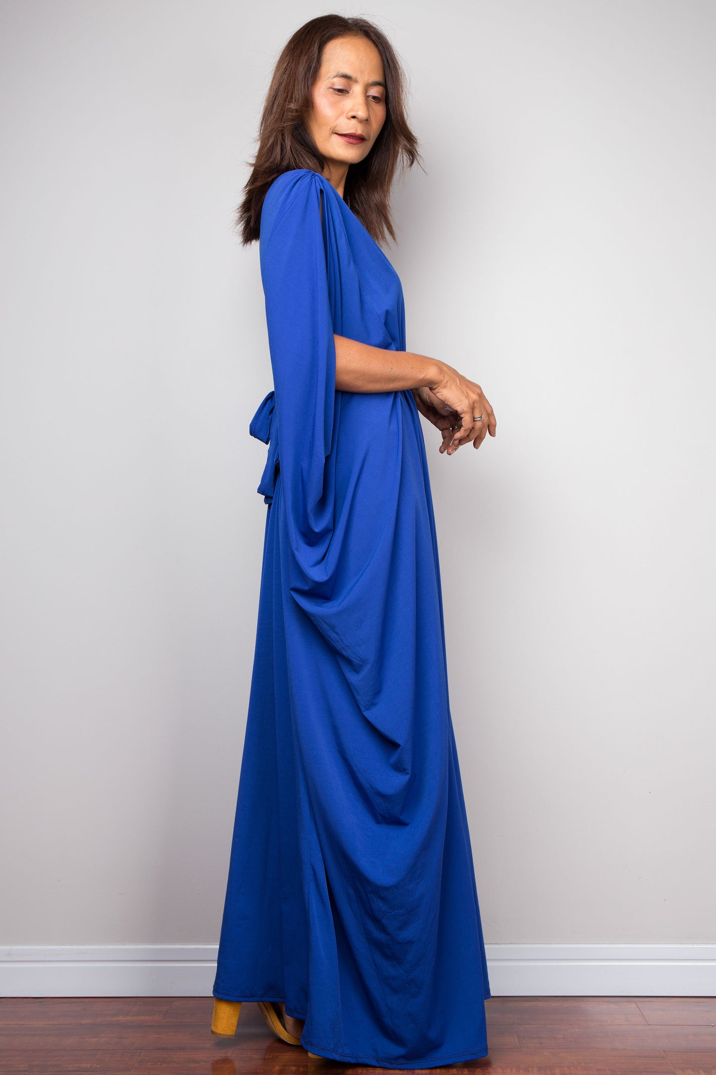 Royal blue kaftan dress with braided waist detail. V neck and batwing sleeve design. Side view - right