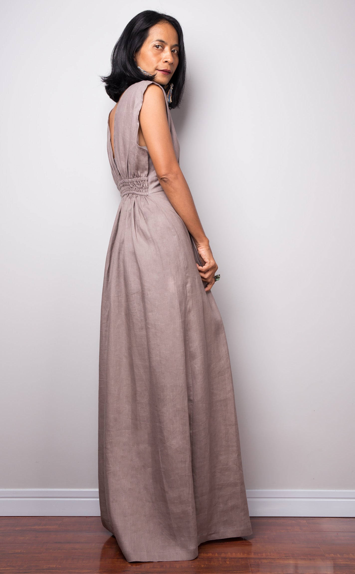 Taupe sleeveless dress with plunging neckline.  High waist design by Nuichan. Back side view