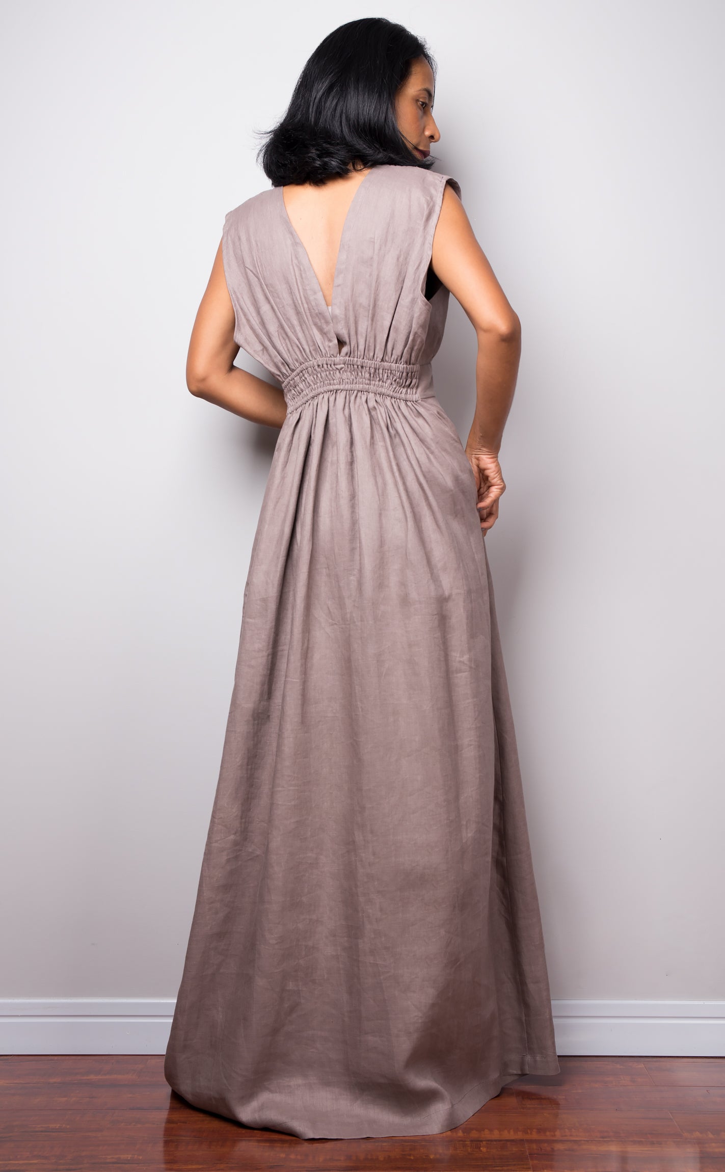 Taupe sleeveless dress with plunging neckline.  High waist design by Nuichan. Back view.