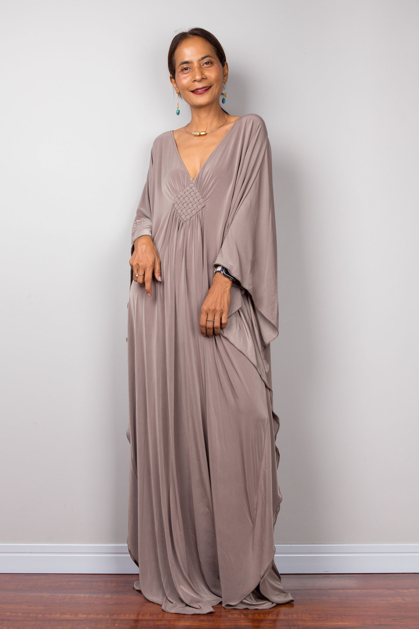 Taupe caftan dress with long sleeves, plunging neckline.