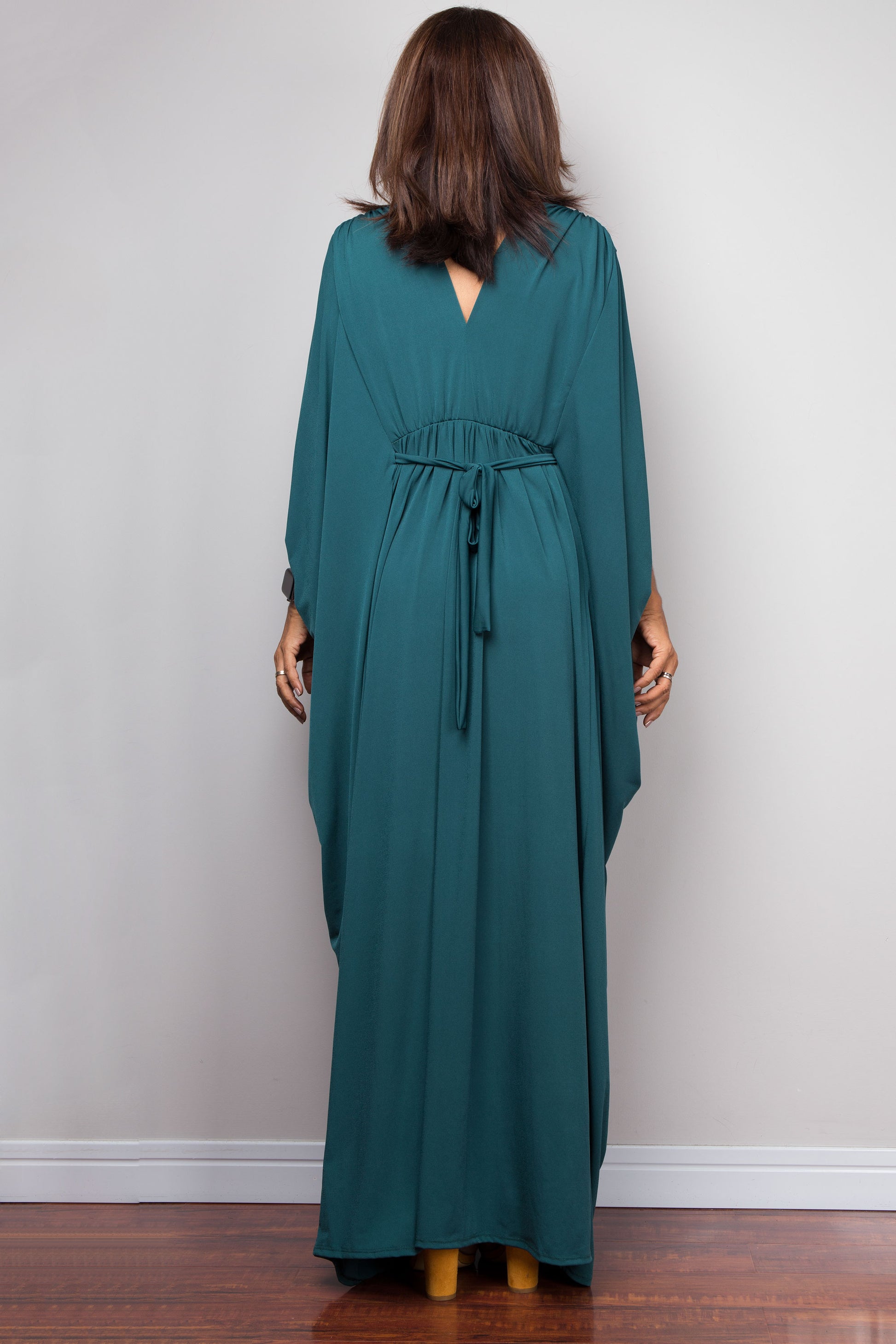 Teal kaftan maxi dress with v neck and braided detail on the waist. Back view