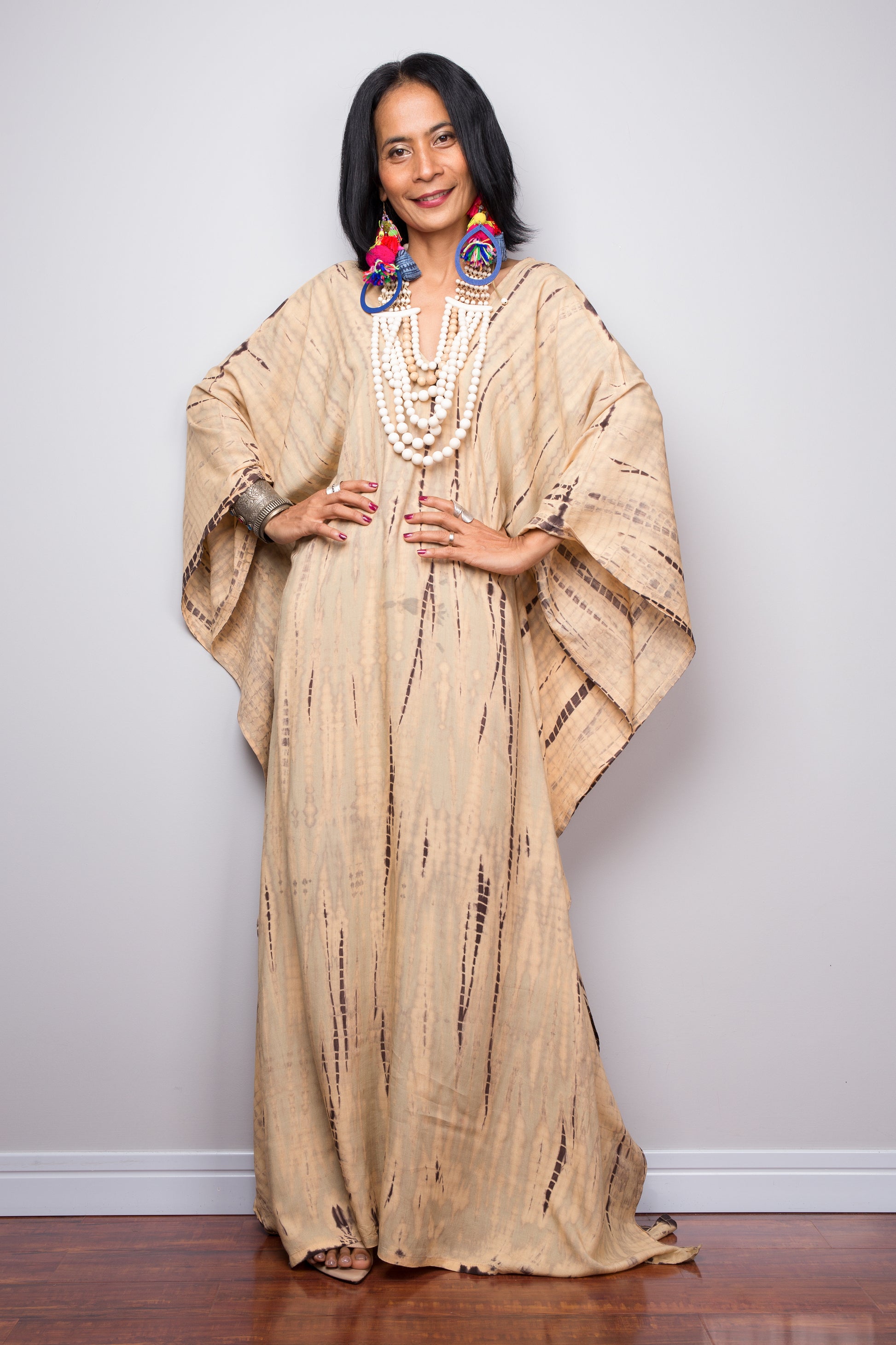 Tie dye beach kaftan with v neck and batwing sleeves. Large loose fitting dress. Front view