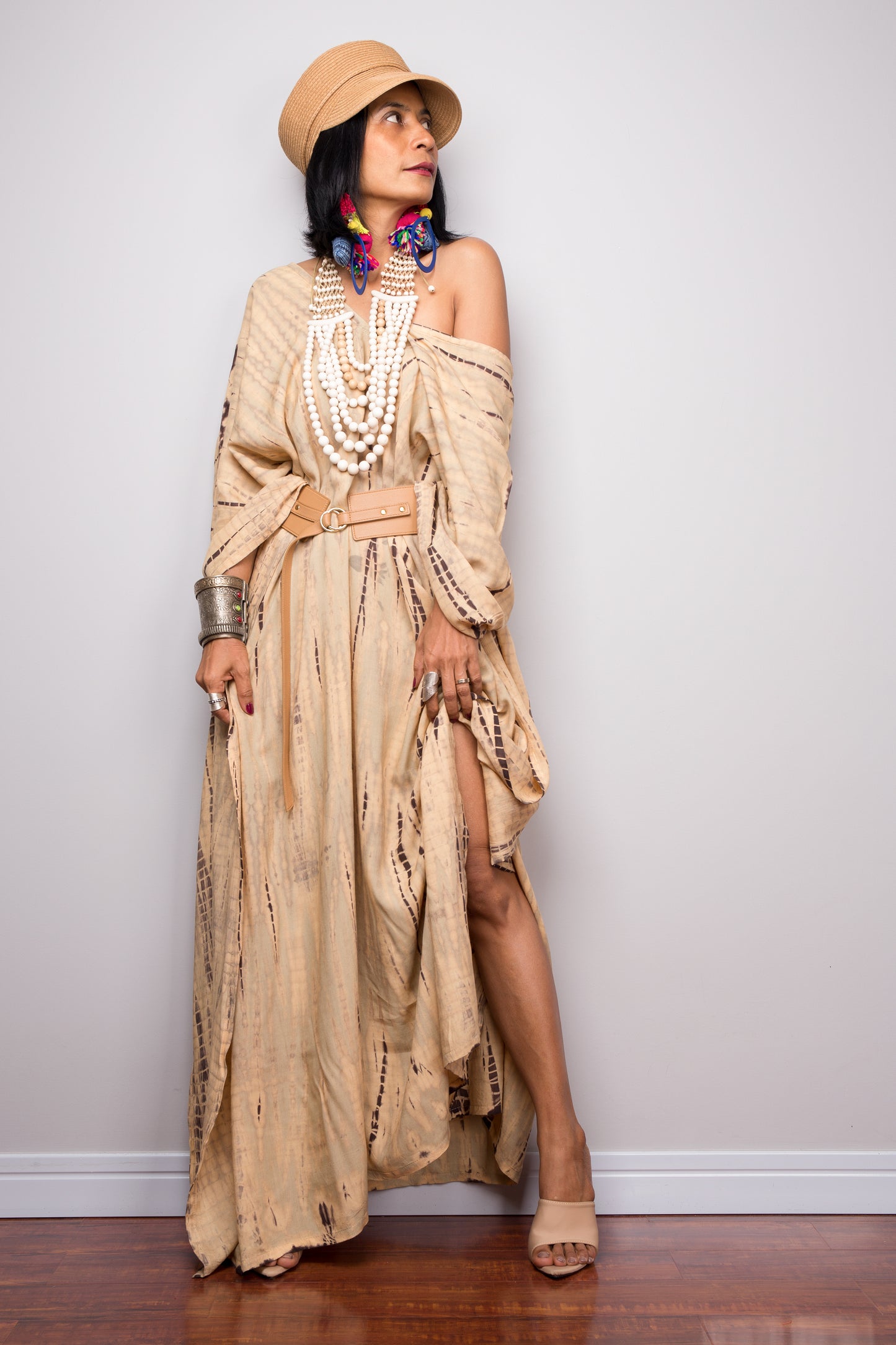 Tie dye beach kaftan with v neck and batwing sleeves. Large loose fitting dress. Nuichan styled the kaftan to wear it off shoulder and with a belt. Split visible.