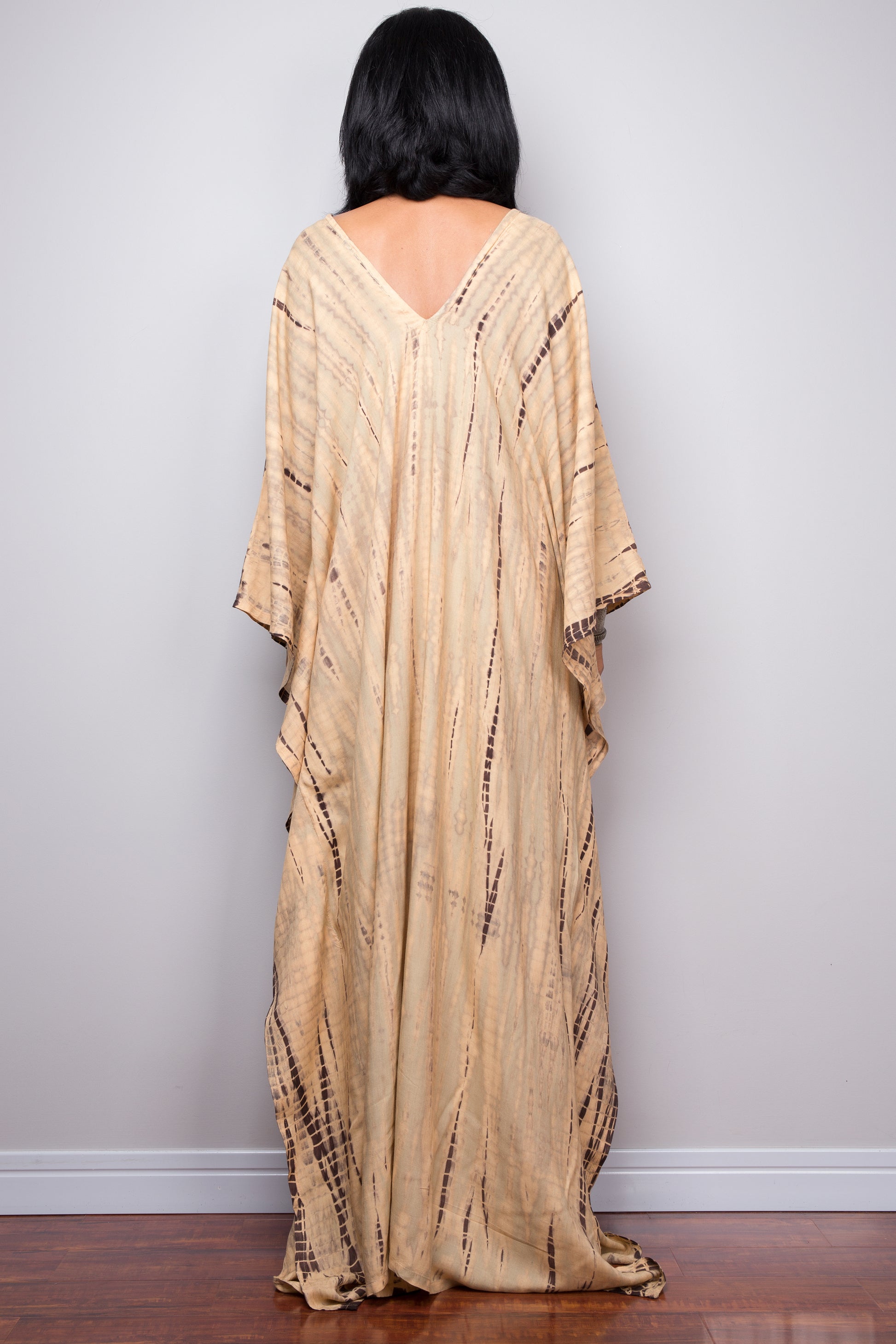 Tie dye beach kaftan with v neck and batwing sleeves. Large loose fitting dress. Back view.