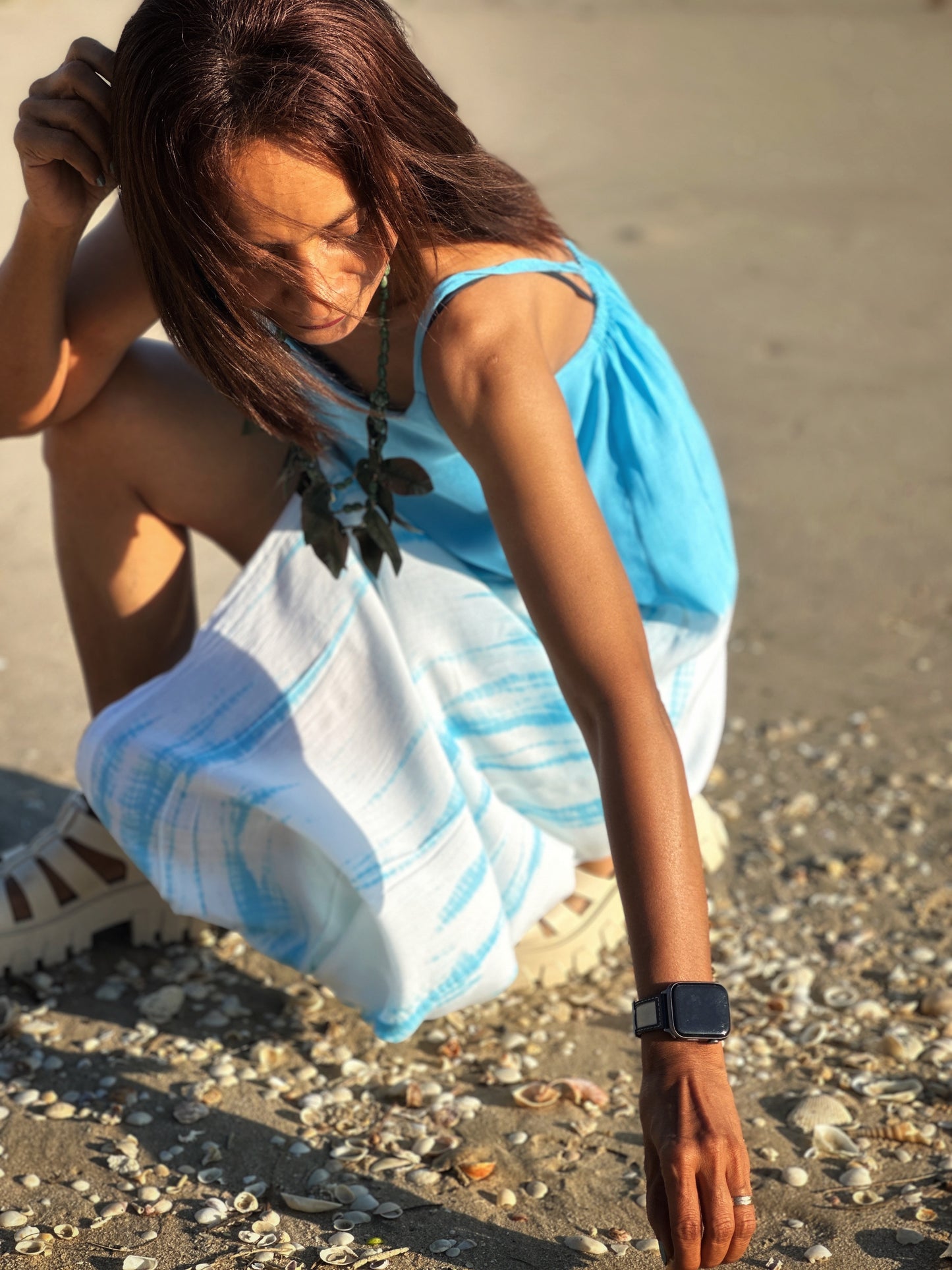 Overhead view of the blue tie dye dress's straps and neckline, showcasing the summery style of the garment.