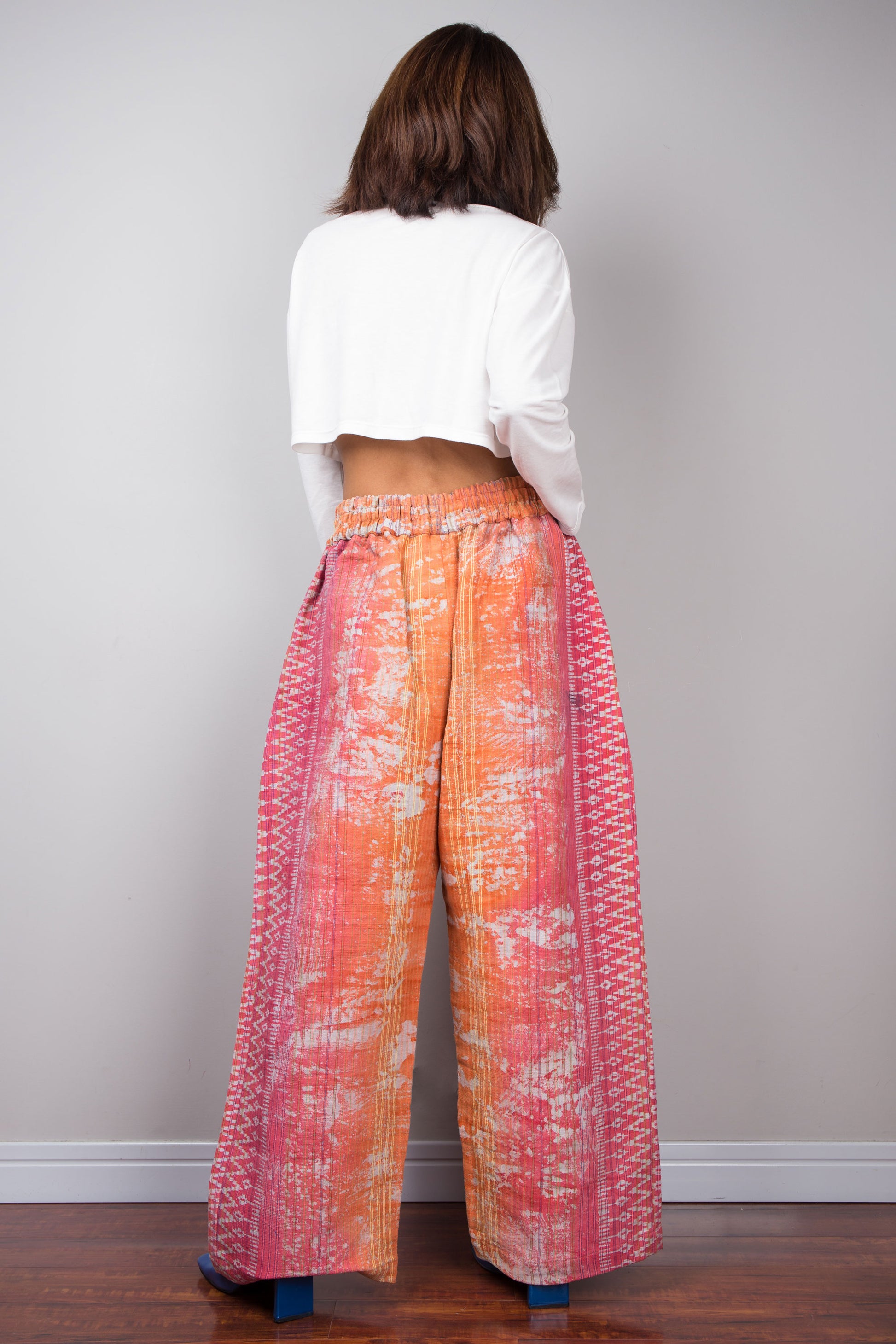 Orange tie dye hemp pants by Nuichan.  Back view