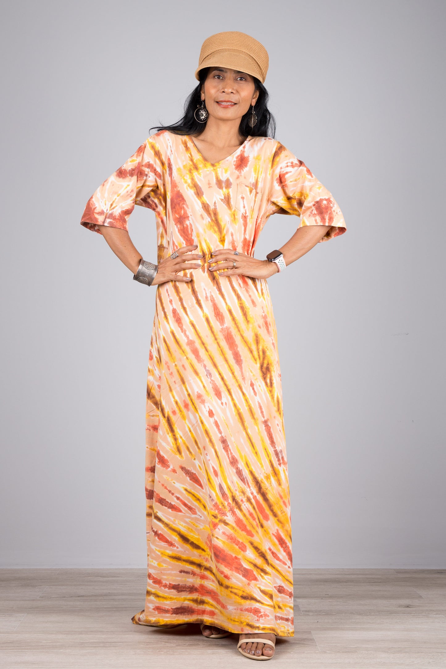 Tie dye maxi dress with mid-length sleeves.  Mostly orange tie dye. 