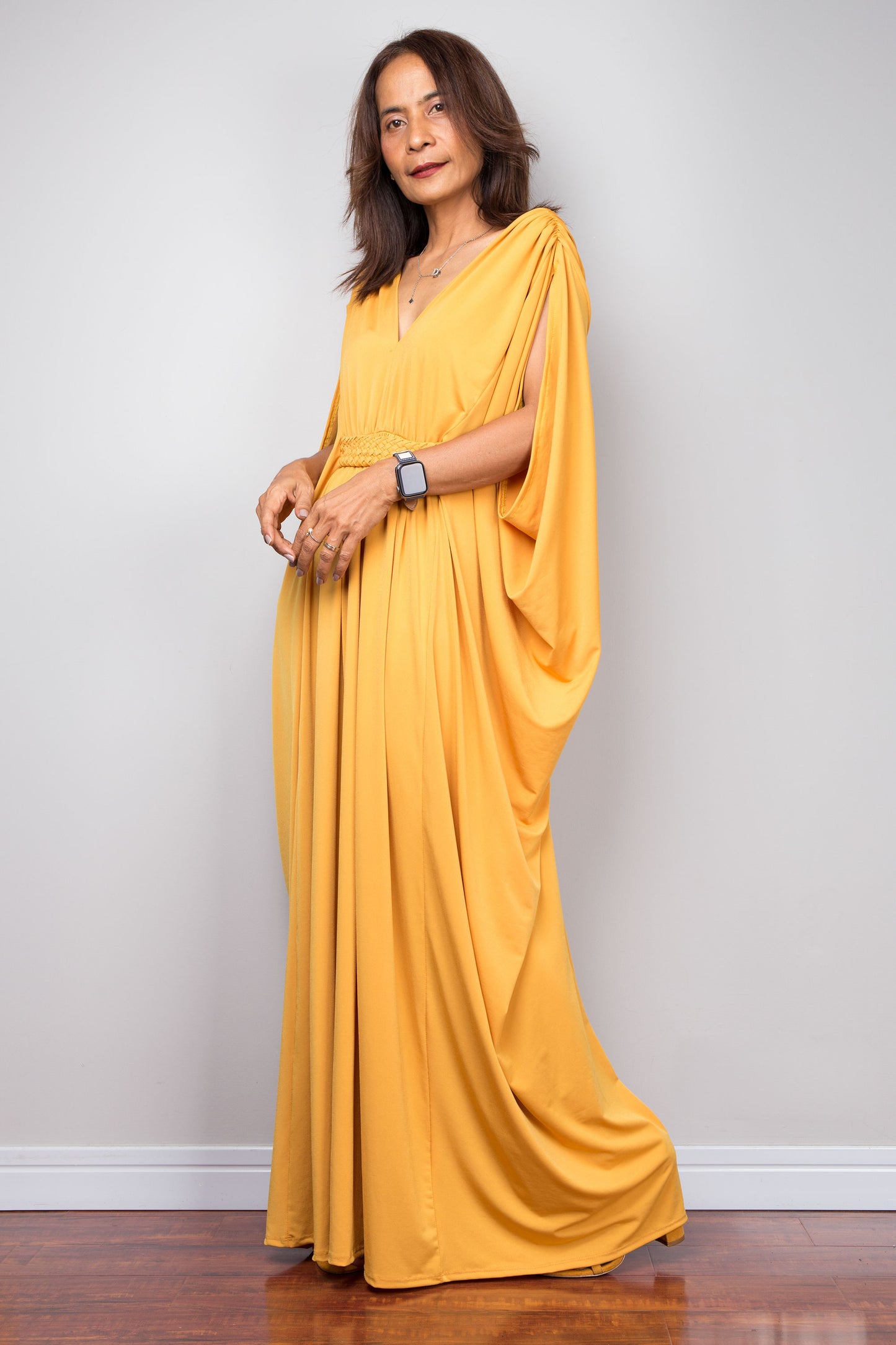 Yellow kaftan maxi dress with braided waist detail and v neck. Side view