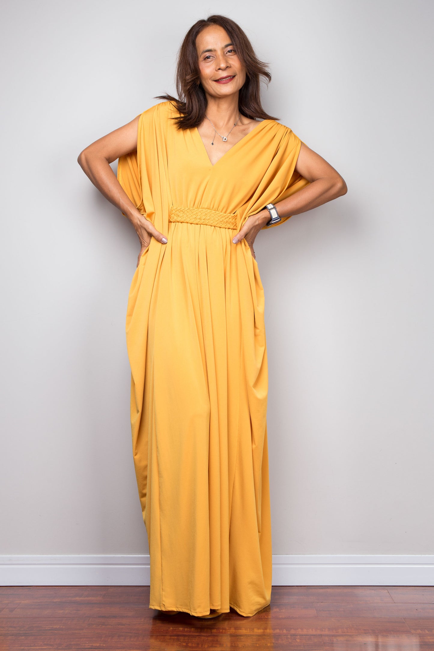 Yellow kaftan maxi dress with braided high waist detail and v neck. Front view