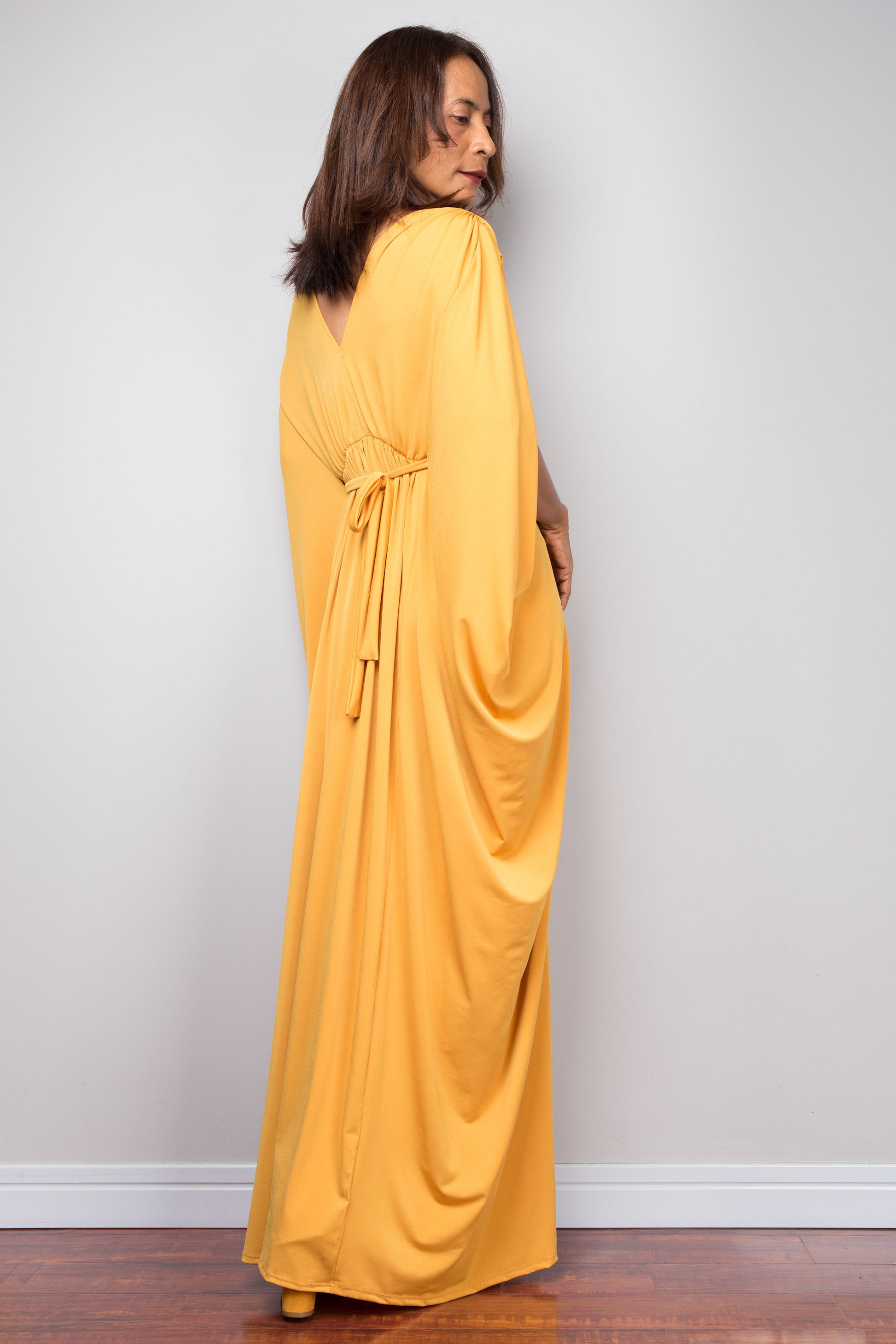 Yellow kaftan maxi dress with braided waist detail and v neck. Back view