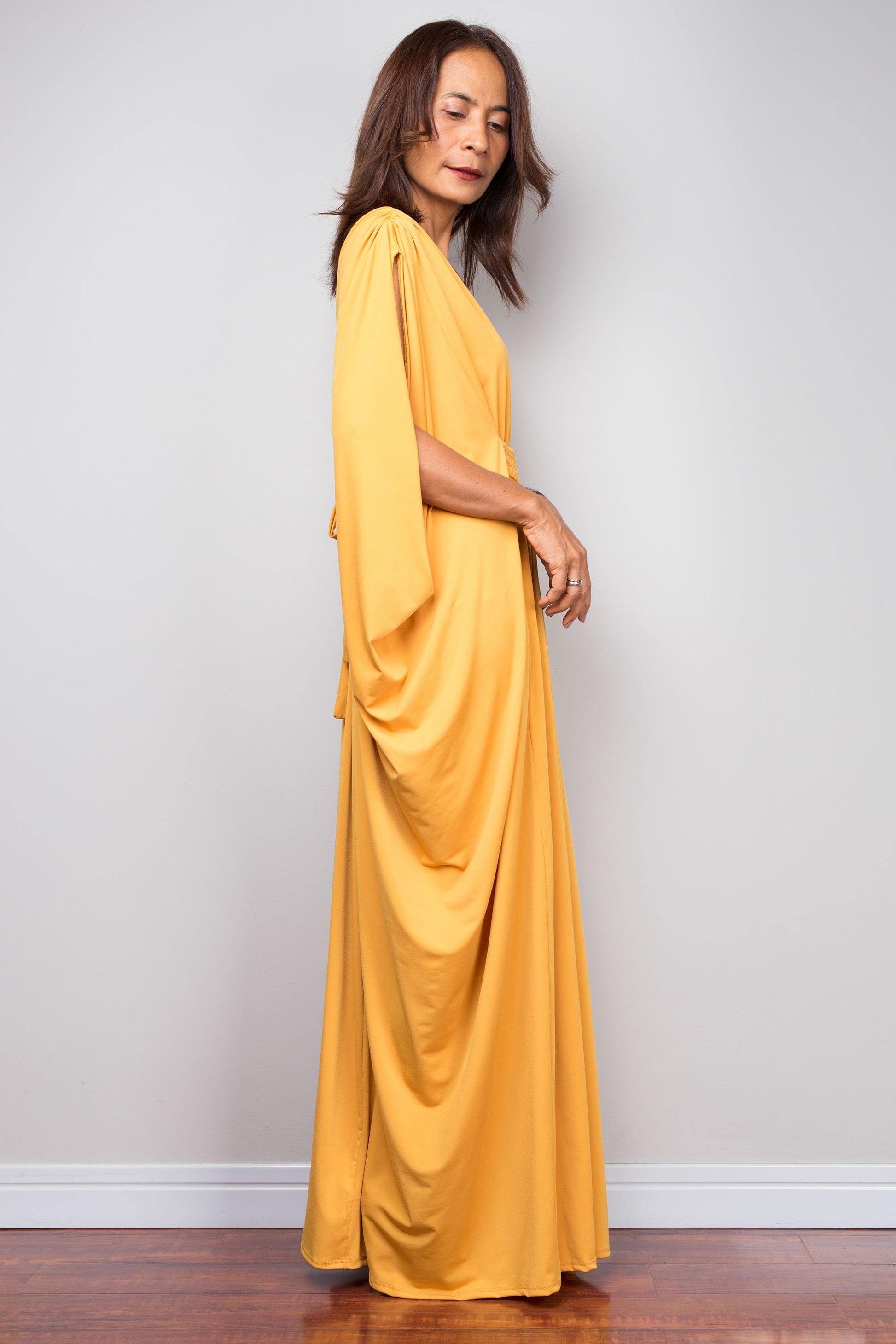 Yellow kaftan maxi dress with braided waist detail and v neck. Side view batwing sleeve dress