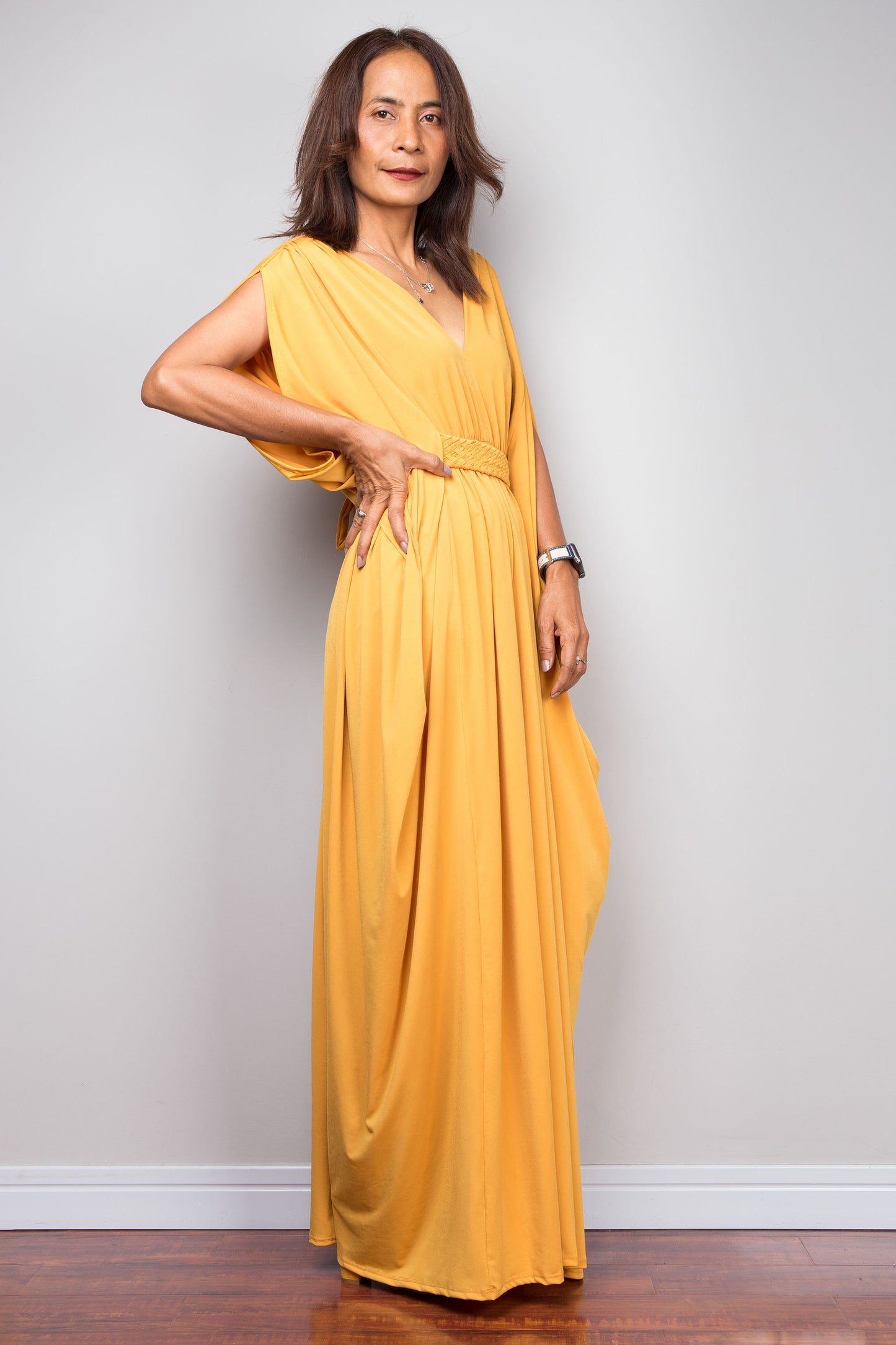 Yellow kaftan maxi dress with braided high waist detail and v neck. Side view