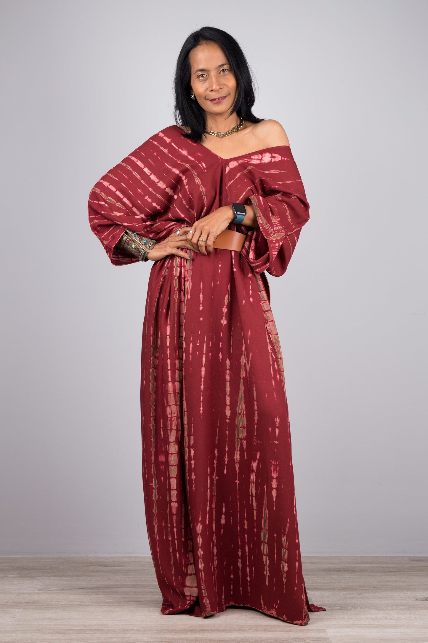 Tie dye dress, kaftan style, in burgundy - front view with one shoulder exposed