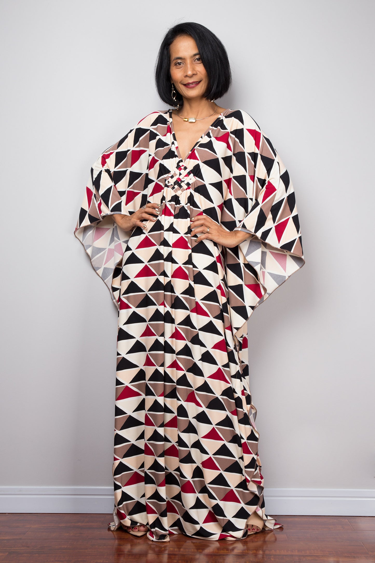 Boho kaftan dress with triangular print. Plunging neckline and batwing sleeves.