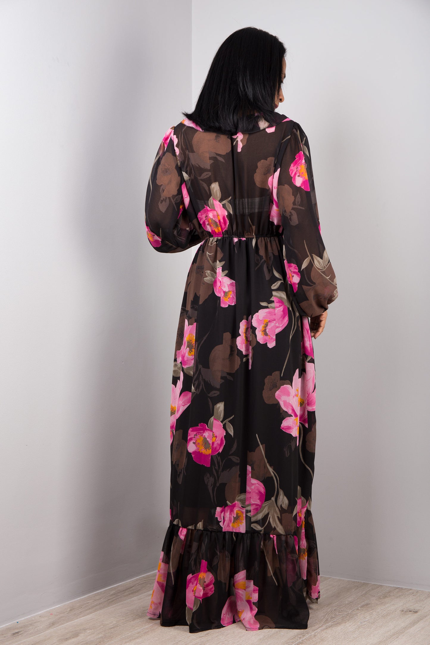 Chiffon maxi dress in black with floral print. Back view.