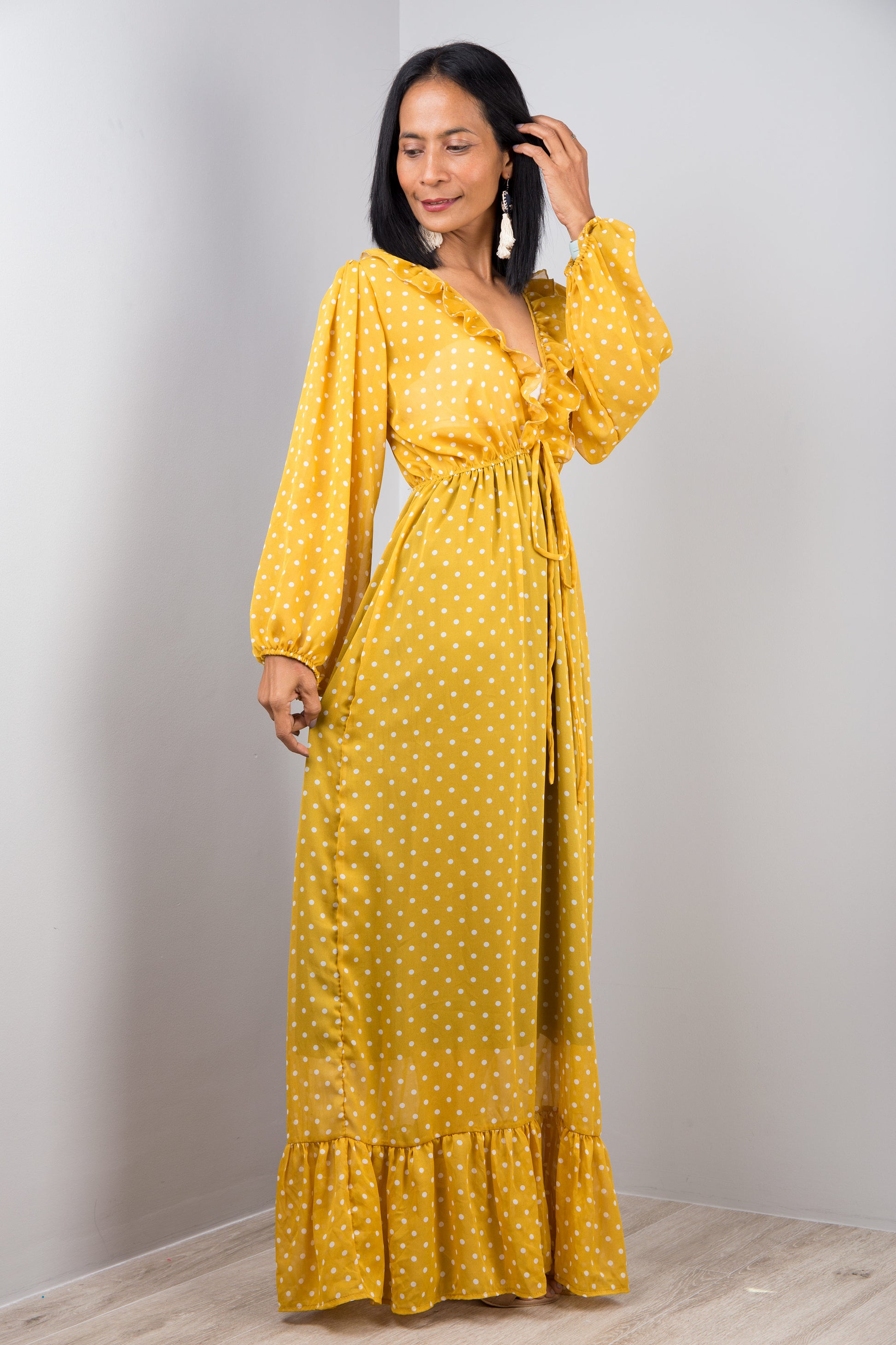 Yellow chiffon maxi dress with long sleeves. Side view.