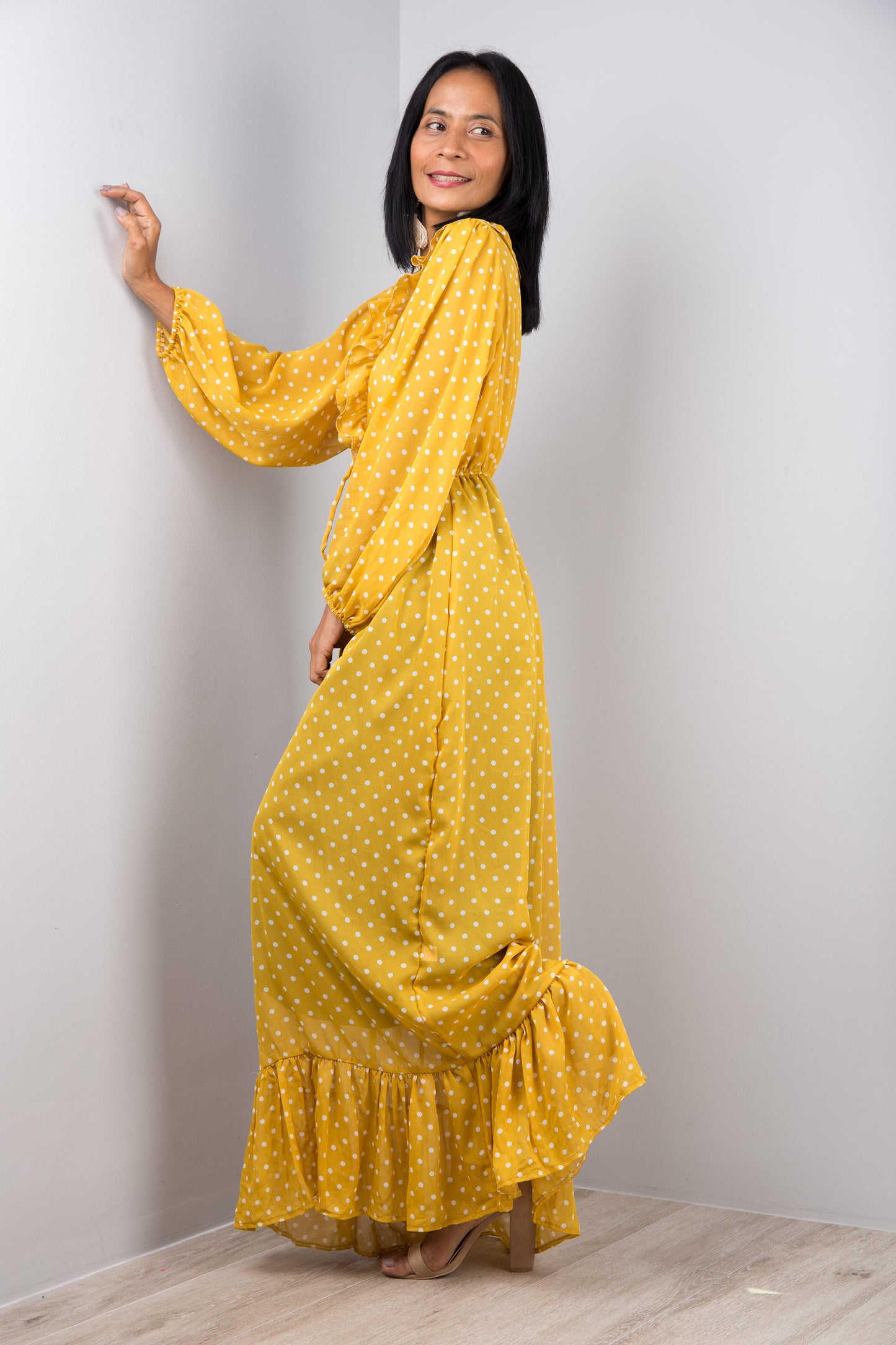 Yellow chiffon maxi dress with long sleeves. Side view.