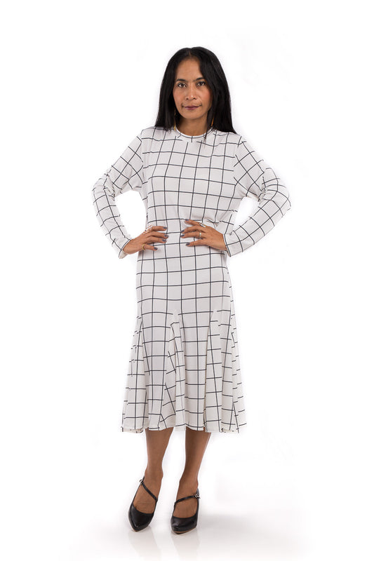 Knee length dress.  White dress with black square print.  Modest neckline and long sleeves.  Tube dress with pleated bottom part by Nuichan.