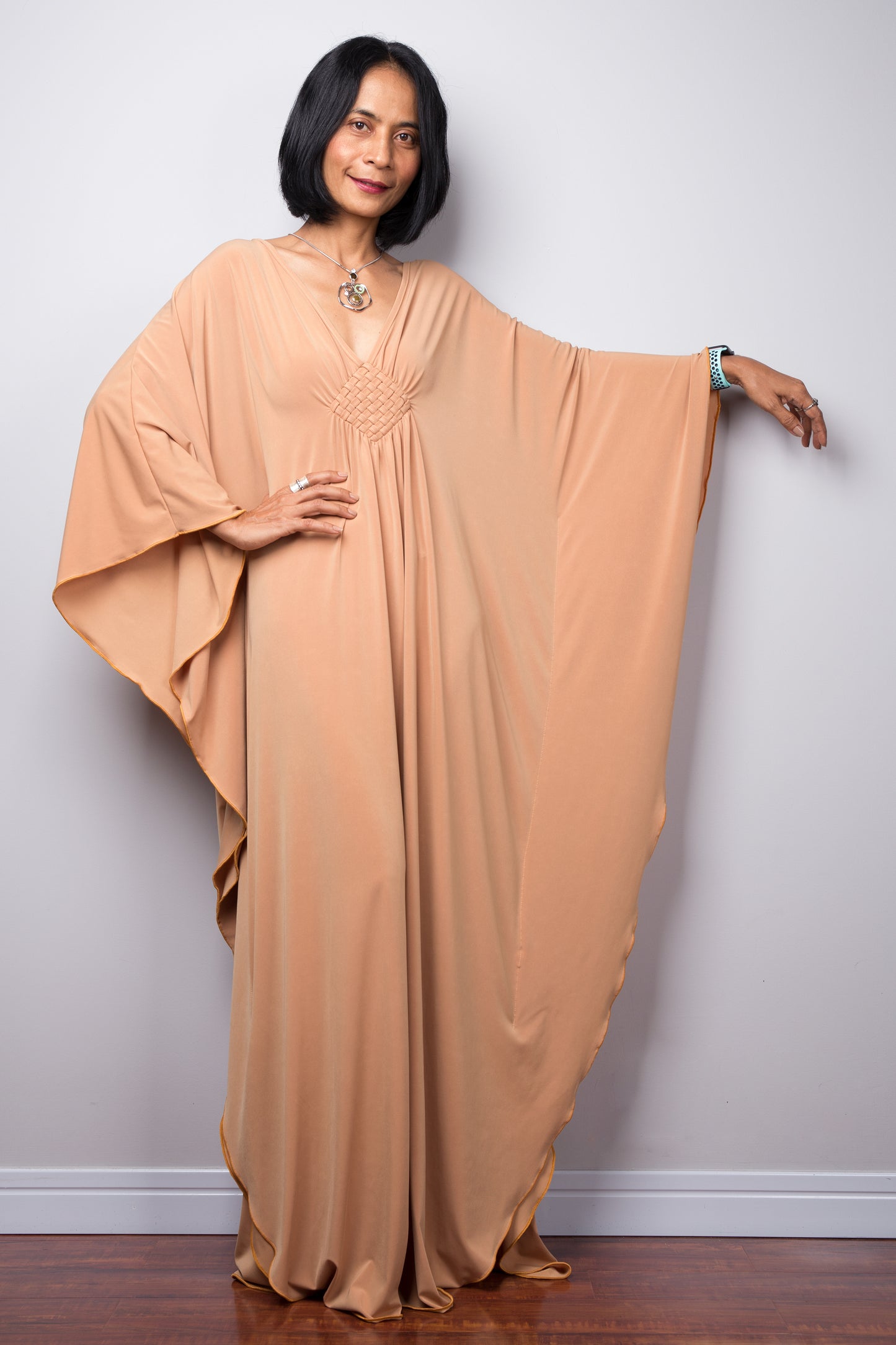 Long kaftan dress by Nuichan. V neck and woven detail on the chest. Batwing sleeves